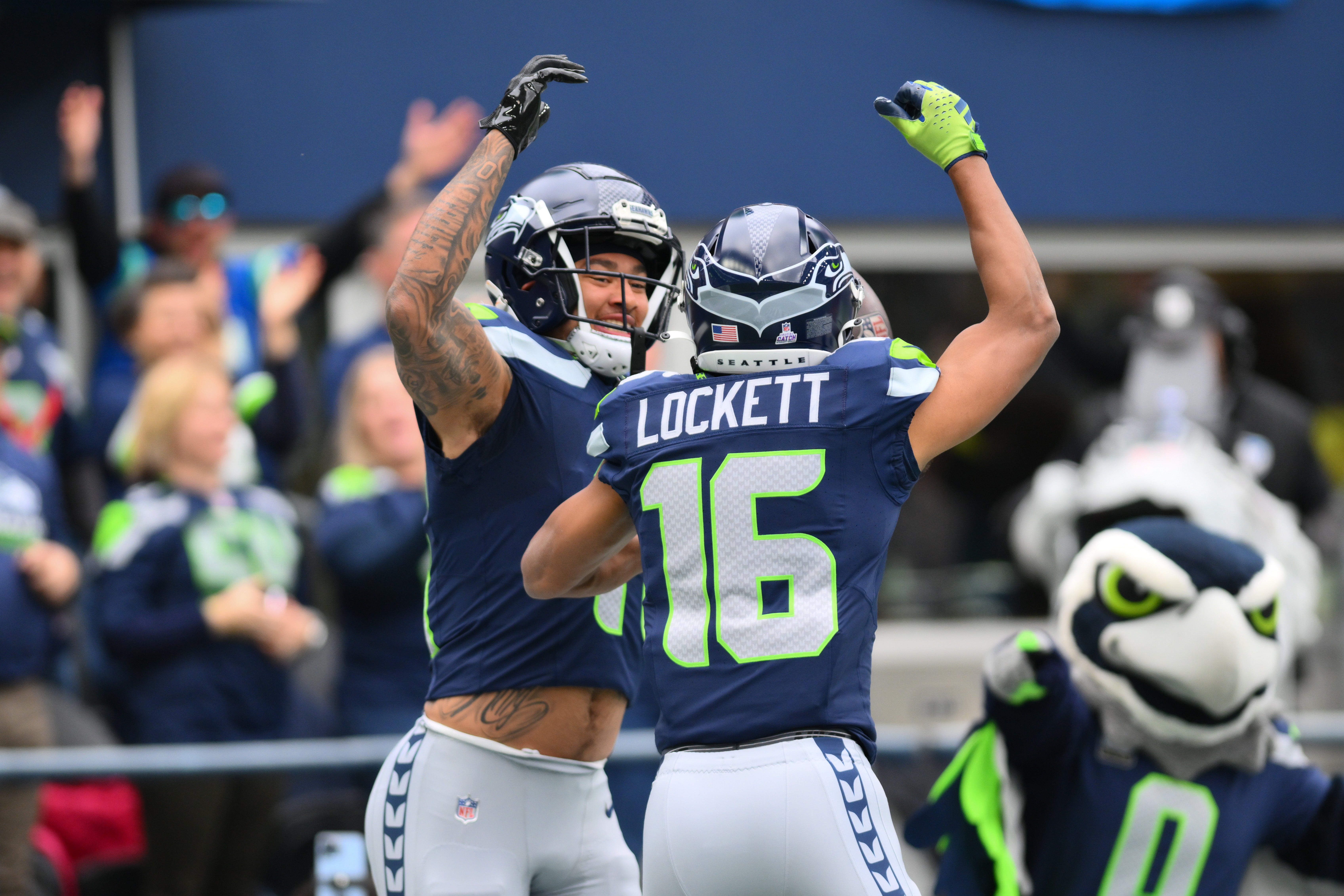 Oct 22, 2023; Seattle, Washington, USA; Seattle Seahawks wide receiver Jaxon Smith-Njigba (11) and Seattle Seahawks wide receiver Tyler Lockett (16) celebrate after Jaxon Smith-Njigba scored a touchdown against the Arizona Cardinals during the first half at Lumen Field. Mandatory Credit: Steven Bisig-USA TODAY Sports