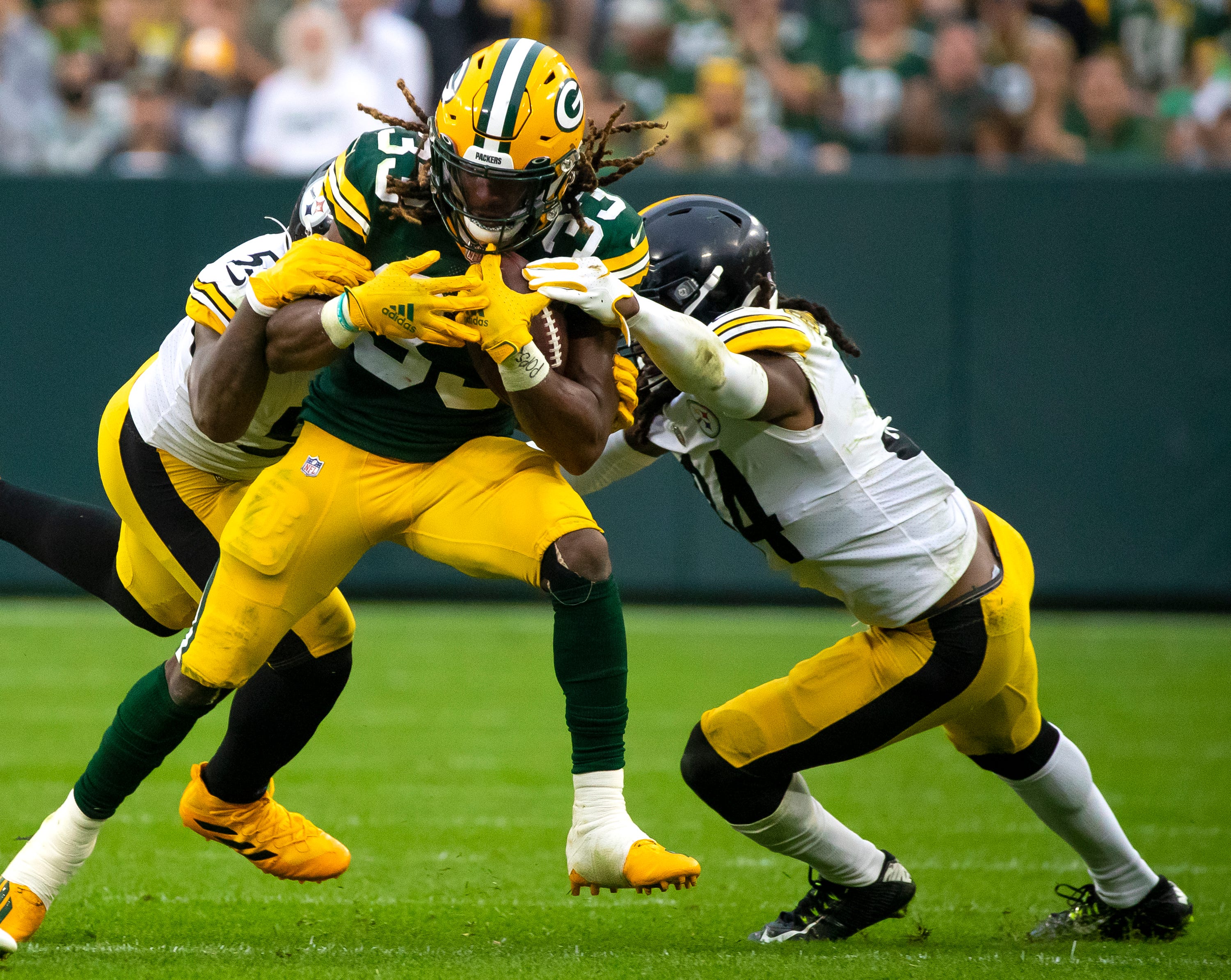 Green Bay Packers running back Aaron Jones (33) is tackled by Pittsburgh Steelers inside linebacker Devin Bush (55) and strong safety Terrell Edmunds (34) in the third quarter at Lambeau Field, Sunday, Oct. 3, 2021, in Green Bay, Wis. Samantha Madar/USA TODAY NETWORK-Wisconsin Gpg Packersvsteelers 100321 0004