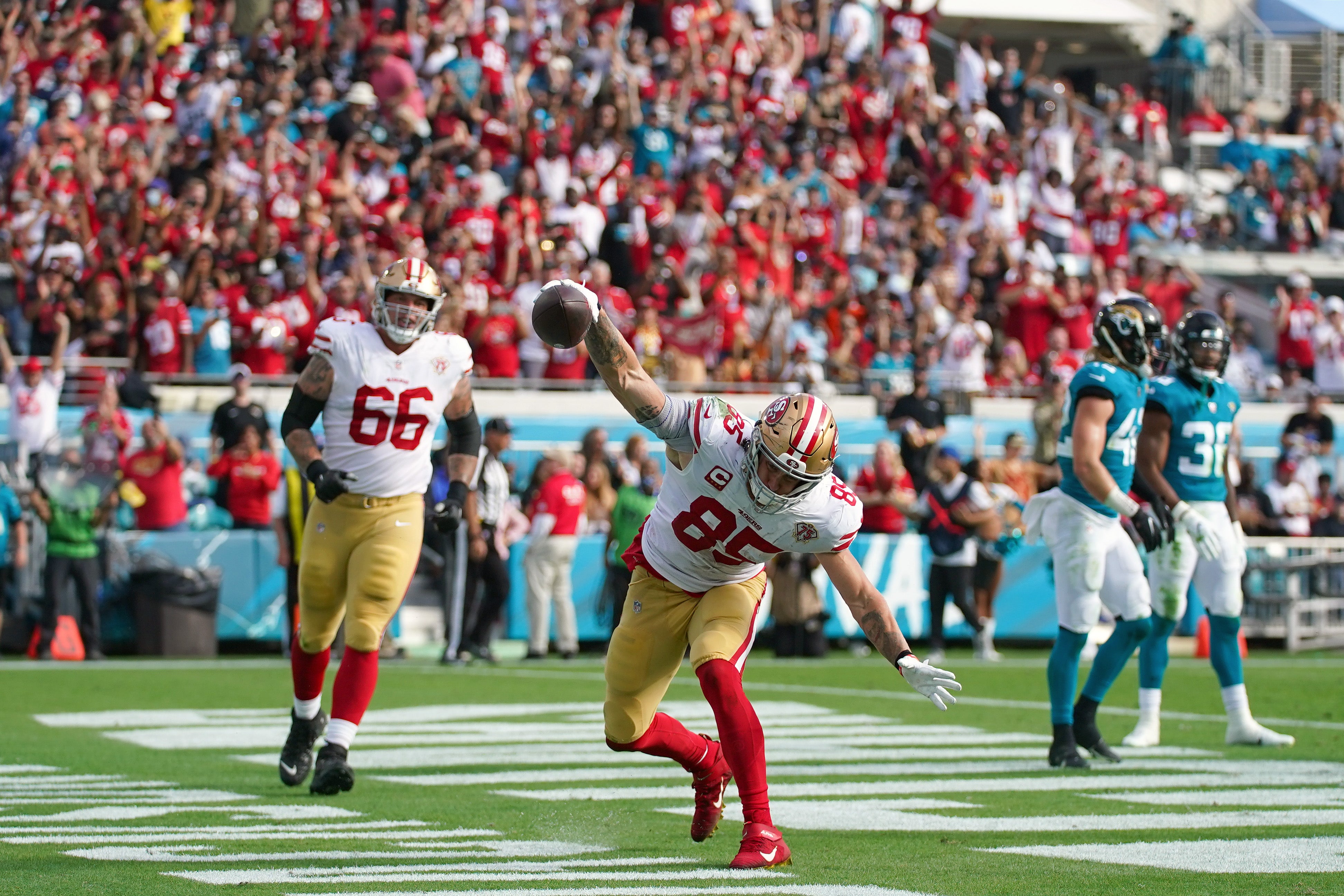 Nov 21, 2021; Jacksonville, Florida, USA; San Francisco 49ers tight end George Kittle (85) spikes the ball after scoring a touchdown against the Jacksonville Jaguars during the second half at TIAA Bank Field.