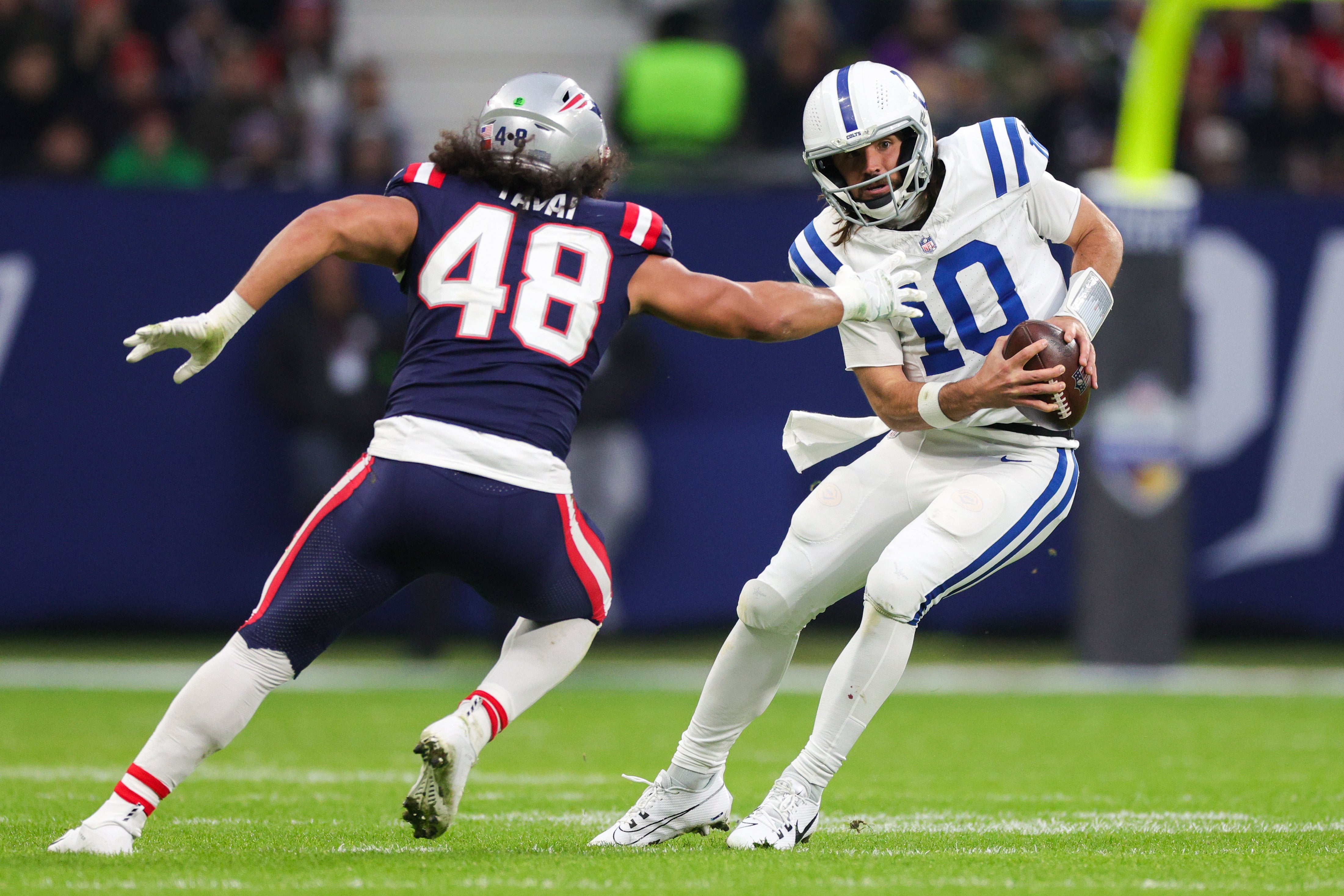 Nov 12, 2023; Frankfurt, Germany; Indianapolis Colts quarterback Gardner Minshew (10) avoids a tackle from New England Patriots linebacker Jahlani Tavai (48) in the second quarter during an International Series game at Deutsche Bank Park.