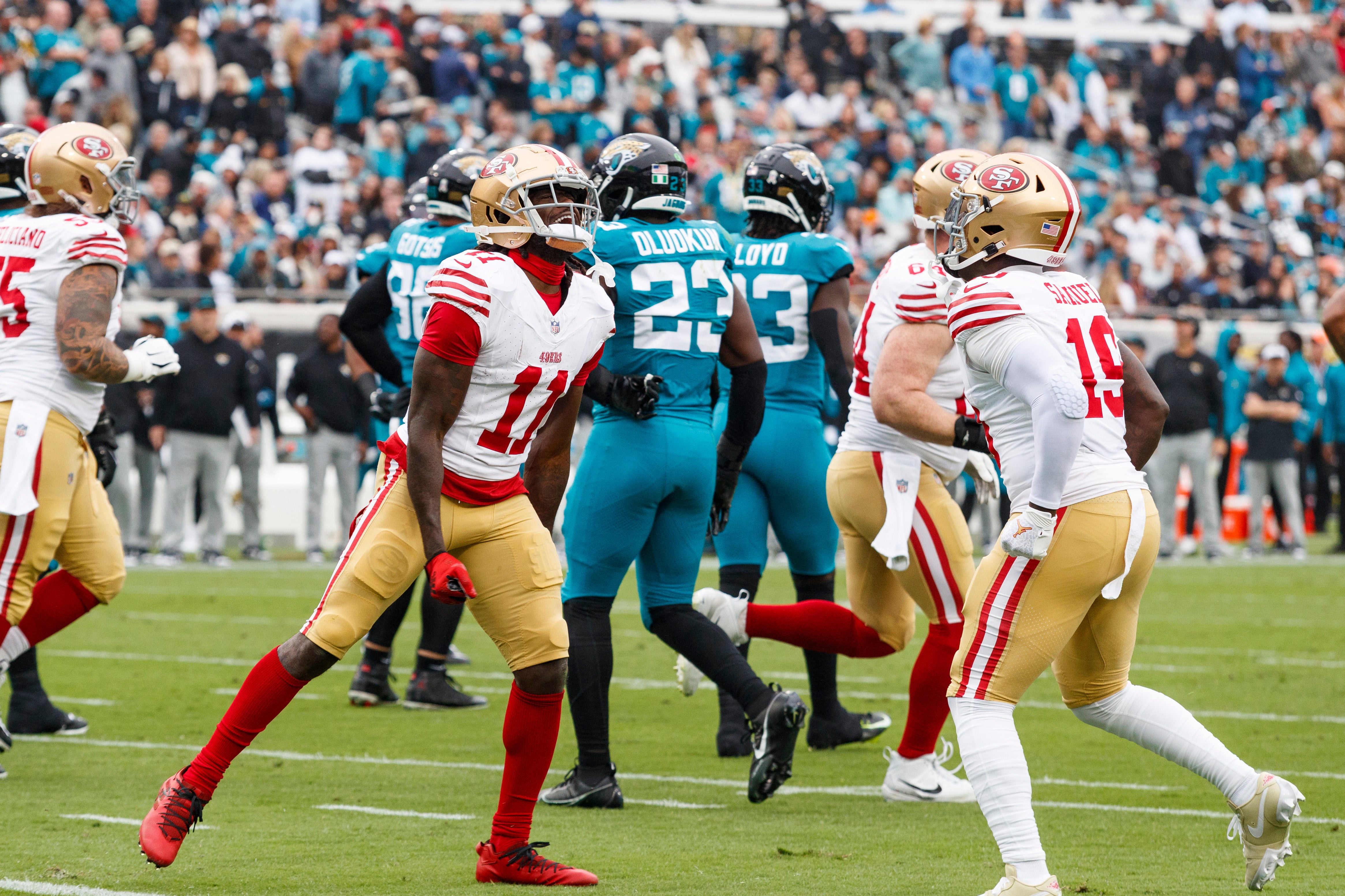 Nov 12, 2023; Jacksonville, Florida, USA; San Francisco 49ers wide receiver Brandon Aiyuk (11) and wide receiver Deebo Samuel (19) celebrate a touchdown against the Jacksonville Jaguars during the first quarter at EverBank Stadium.
