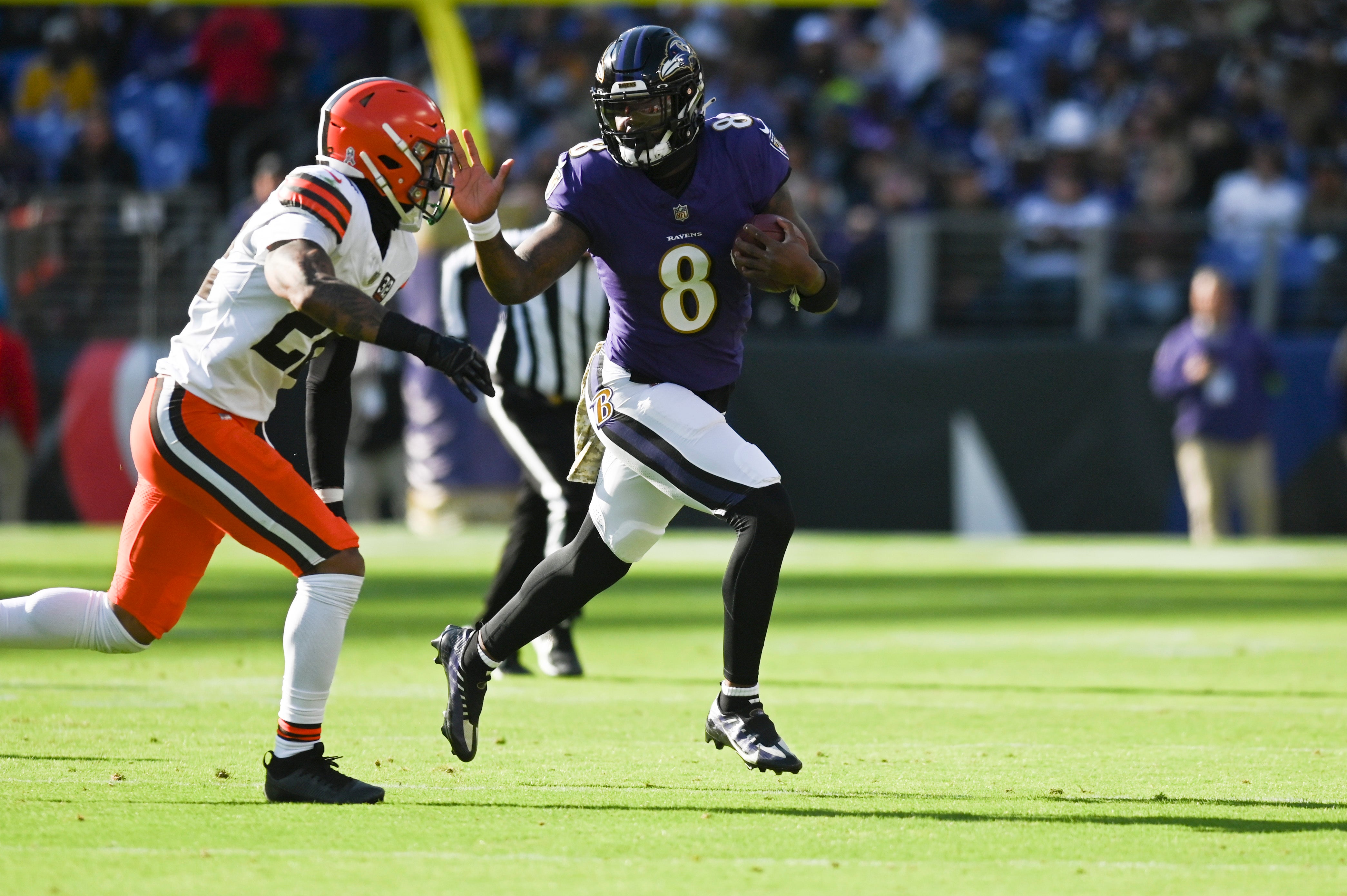Baltimore Ravens quarterback Lamar Jackson (8) rushes as Cleveland Browns cornerback Martin Emerson Jr. (23) defends during the first half at M&T Bank Stadium. Mandatory Credit: Tommy Gilligan-USA