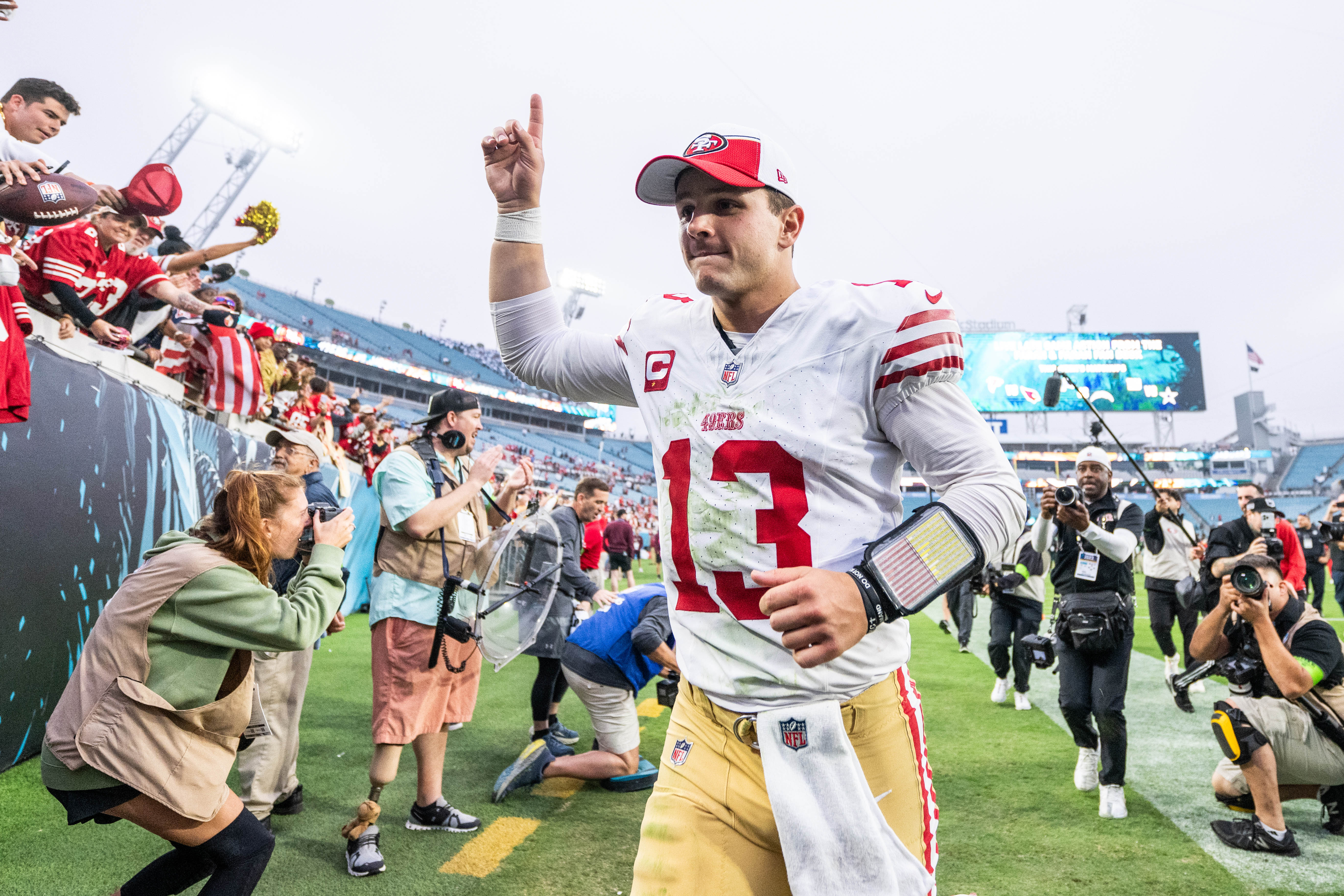 Nov 12, 2023; Jacksonville, Florida, USA; San Fransisco 49ers quarterback Brock Purdy (13) celebrates the win over the Jacksonville Jaguars after the game at EverBank Stadium.