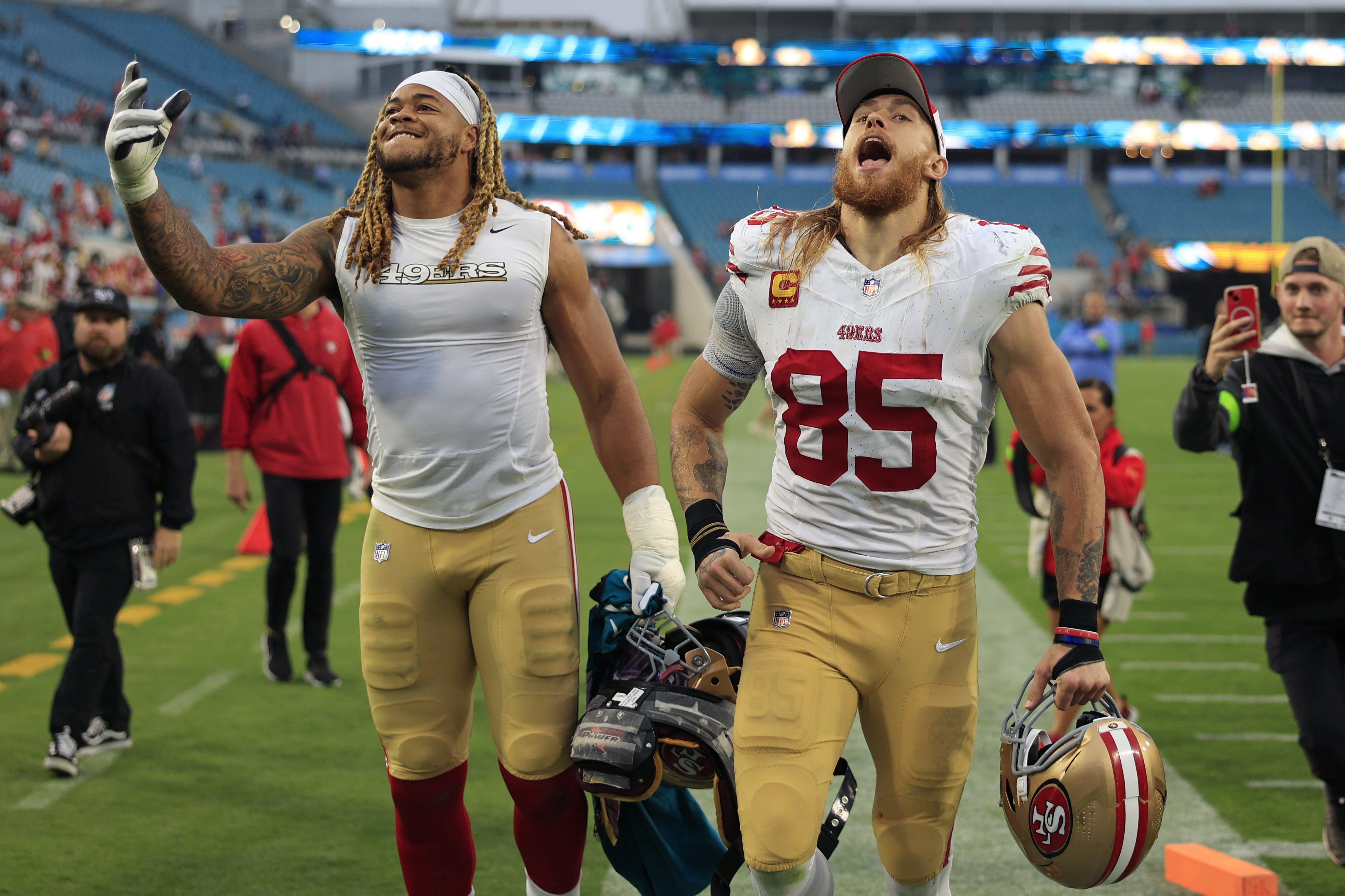 San Francisco 49ers defensive end Chase Young (92), left, and tight end George Kittle (85) run off the field while celebrating the win after the game of an NFL football game Sunday, Nov. 12, 2023 at EverBank Stadium in Jacksonville, Fla. The San Francisco 49ers defeated the Jacksonville Jaguars 34-3.