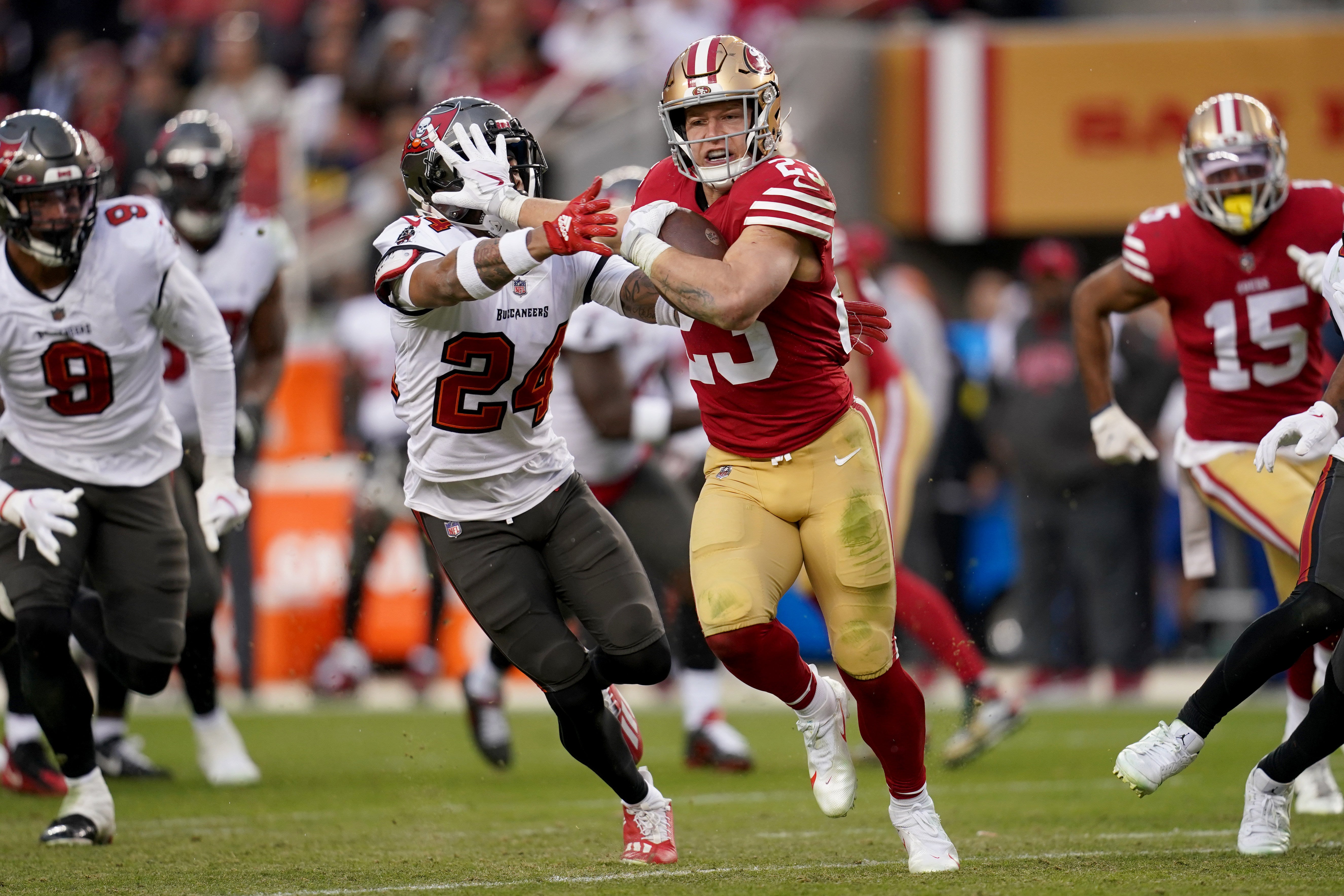 Dec 11, 2022; Santa Clara, California, USA; San Francisco 49ers running back Christian McCaffrey (23) stiff arms Tampa Bay Buccaneers cornerback Carlton Davis III (24) during a 38 yard touchdown run in the third quarter at Levi's Stadium.