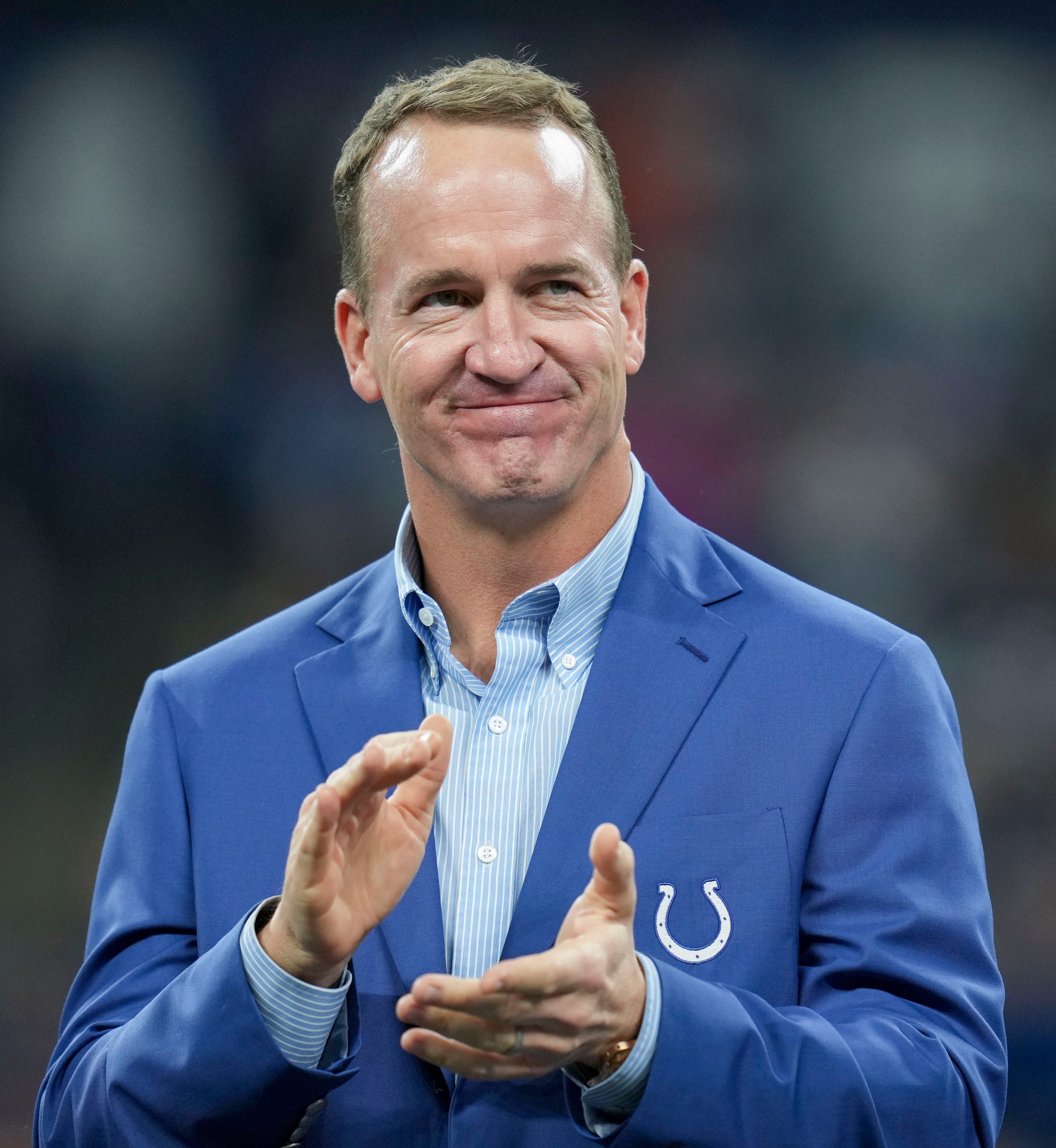 Former Indianapolis Colts quarterback Peyton Manning claps during a Ring of Honor induction ceremony for Tarik Glenn on Sunday, Oct. 30, 2022, during a game against the Washington Commanders at Indianapolis Colts at Lucas Oil Stadium in Indianapolis.
