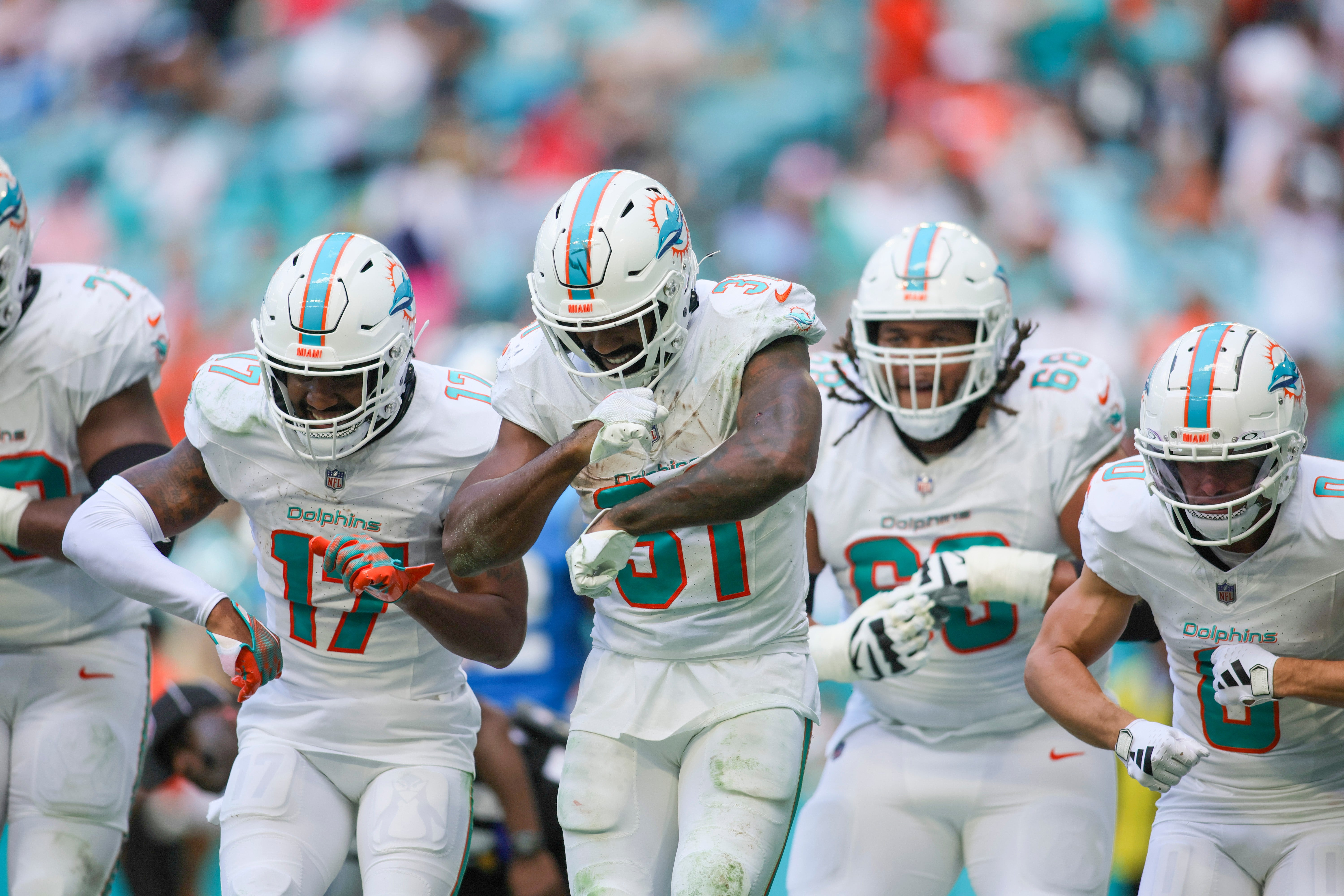 Oct 15, 2023; Miami Gardens, Florida, USA; Miami Dolphins running back Raheem Mostert (31) celebrates with teammates after scoring a touchdown against the Carolina Panthers during the fourth quarter at Hard Rock Stadium. Mandatory Credit: Sam Navarro-USA TODAY Sports
