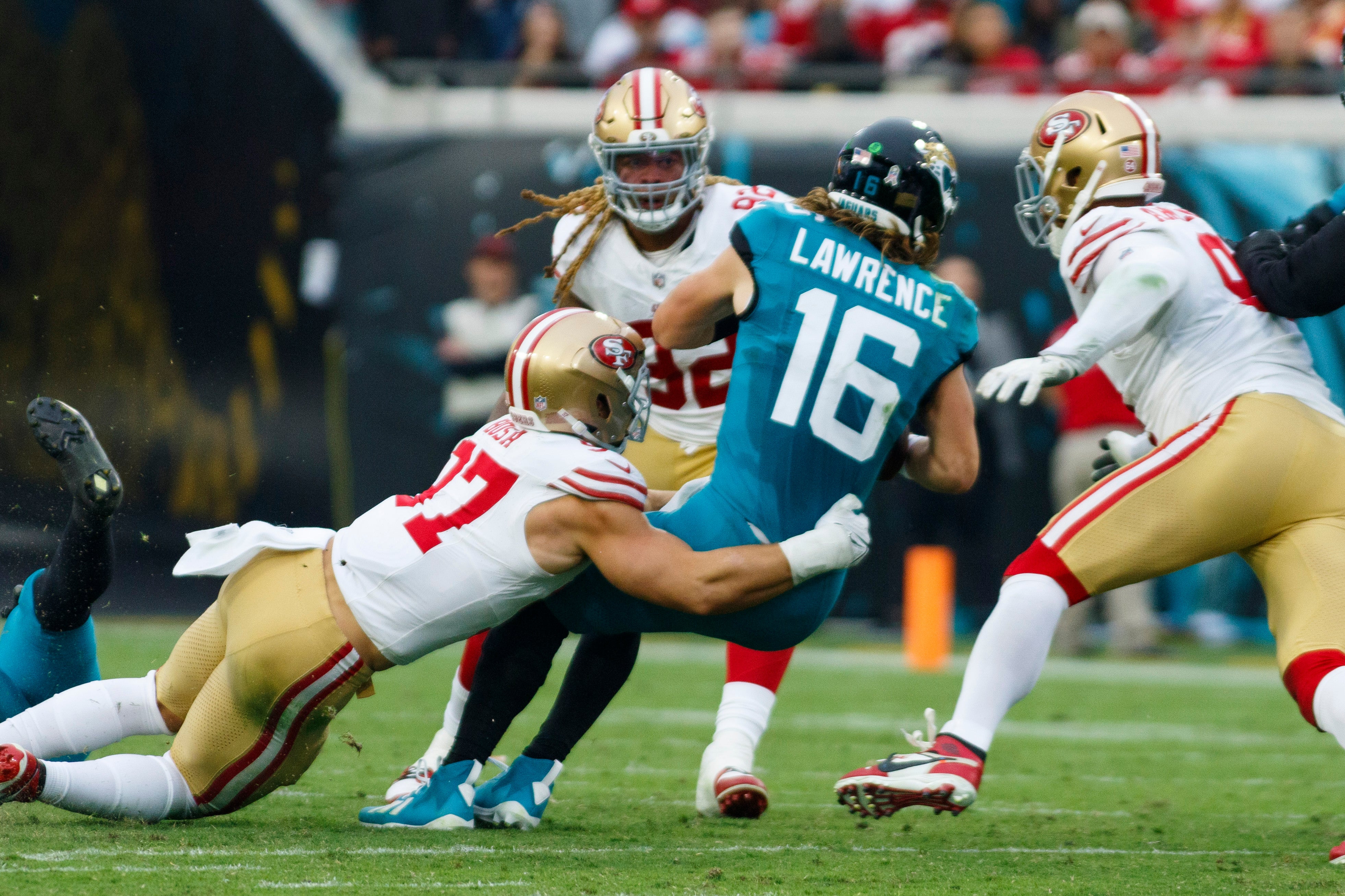 Nov 12, 2023; Jacksonville, Florida, USA; San Francisco 49ers defensive tackle Nick Bosa (97) sacks Jacksonville Jaguars quarterback Trevor Lawrence (16) with San Francisco 49ers defensive tackle Chase Young (92) and defensive tackle Arik Armstead (91) putting pressure during the third quarter at EverBank Stadium.