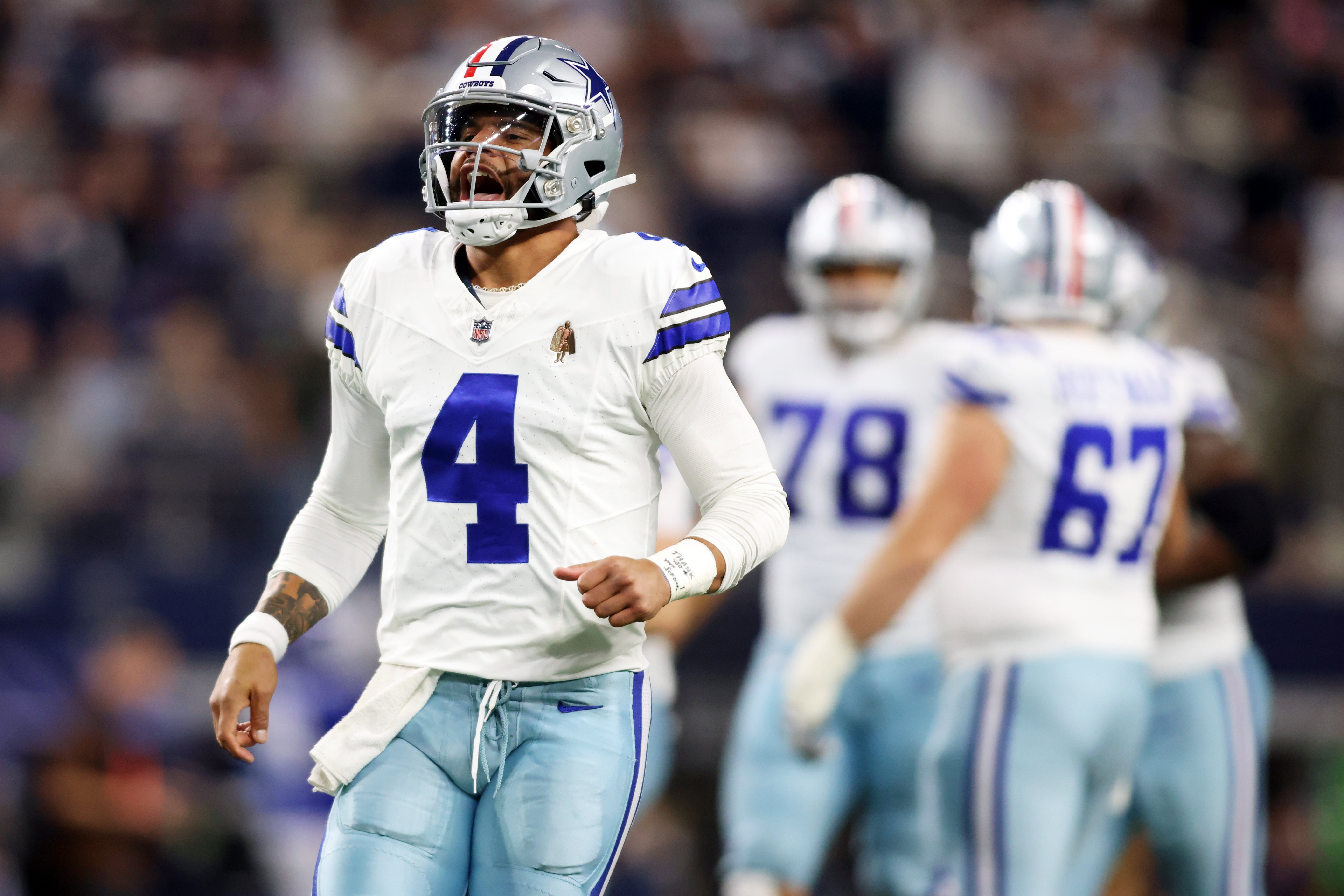 Dallas Cowboys quarterback Dak Prescott (4) celebrates throwing a touchdown pass against the New York Giants in the third quarter at AT&T Stadium.