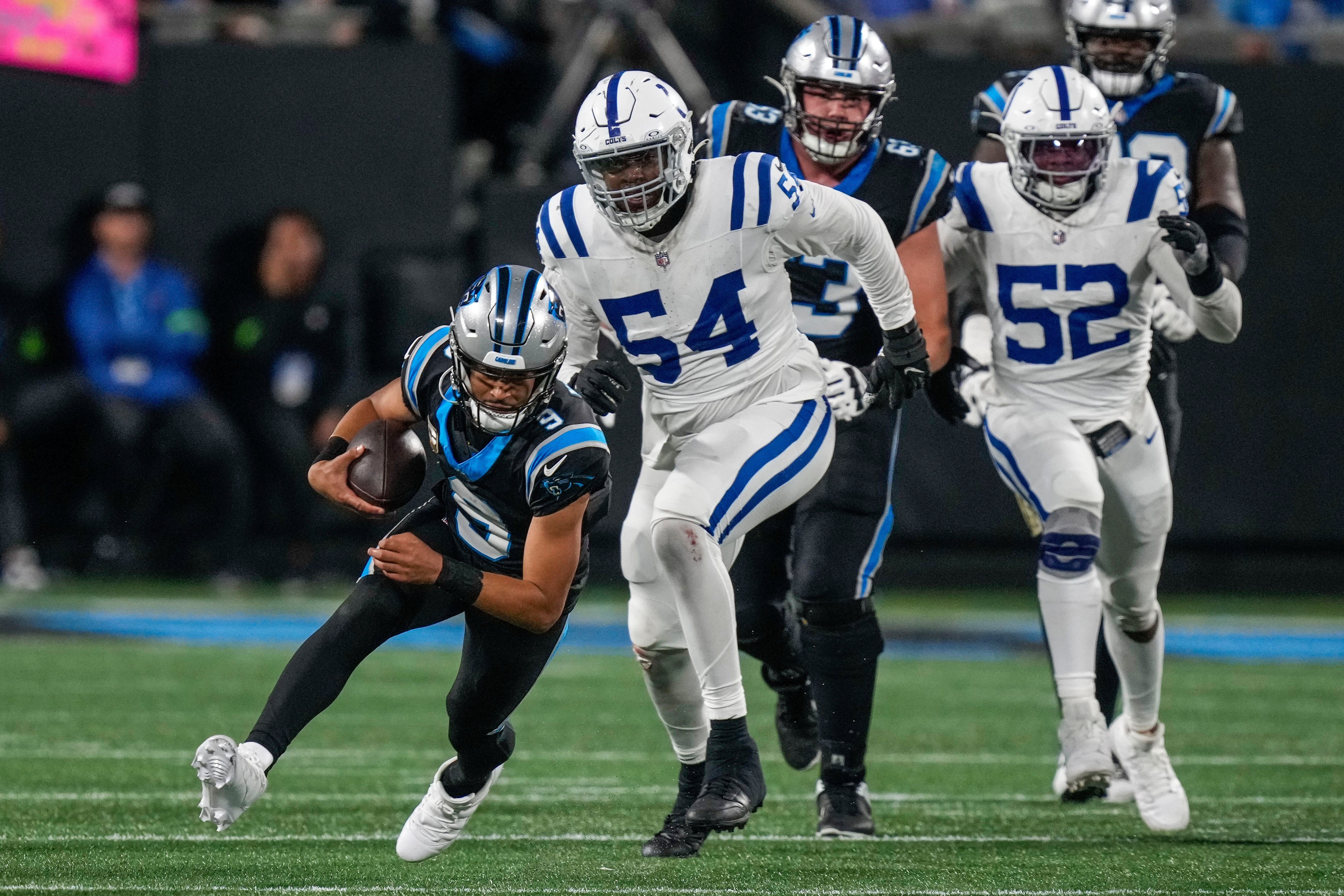 Nov 5, 2023; Charlotte, North Carolina, USA; Carolina Panthers quarterback Bryce Young (9) dives for the turf chased by Indianapolis Colts defensive end Dayo Odeyingbo (54) during the second half at Bank of America Stadium.