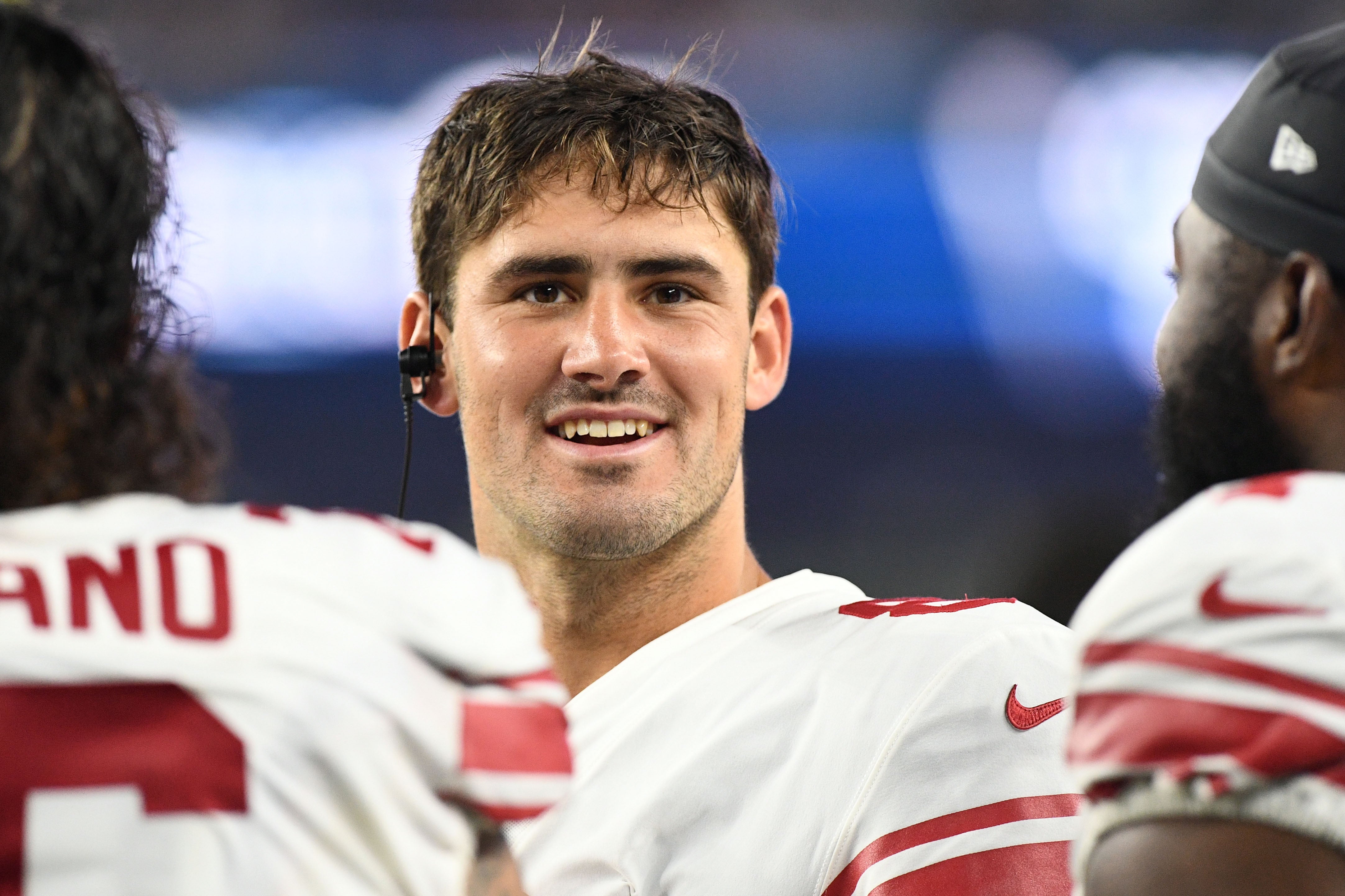 New York Giants quarterback Daniel Jones talks with his teammates on the bench during the first half of a preseason game at Gillette Stadium