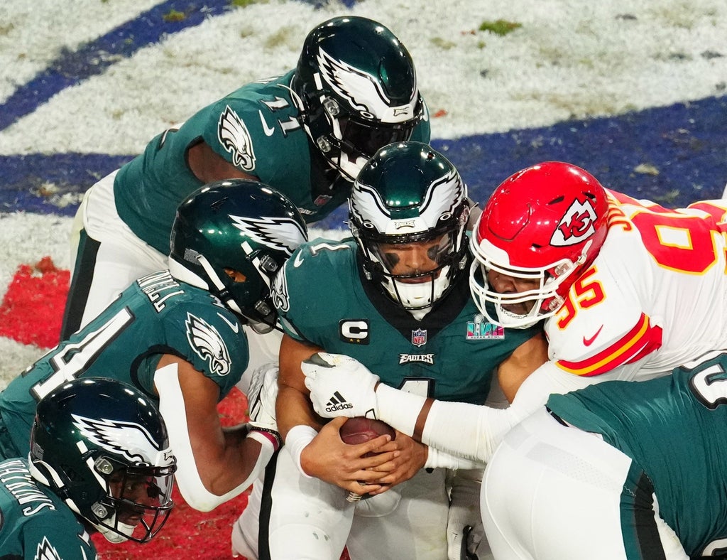 Philadelphia Eagles quarterback Jalen Hurts picks up a first down on a quarterback sneak against Kansas City Chiefs defensive tackle Chris Jones Super Bowl LVII