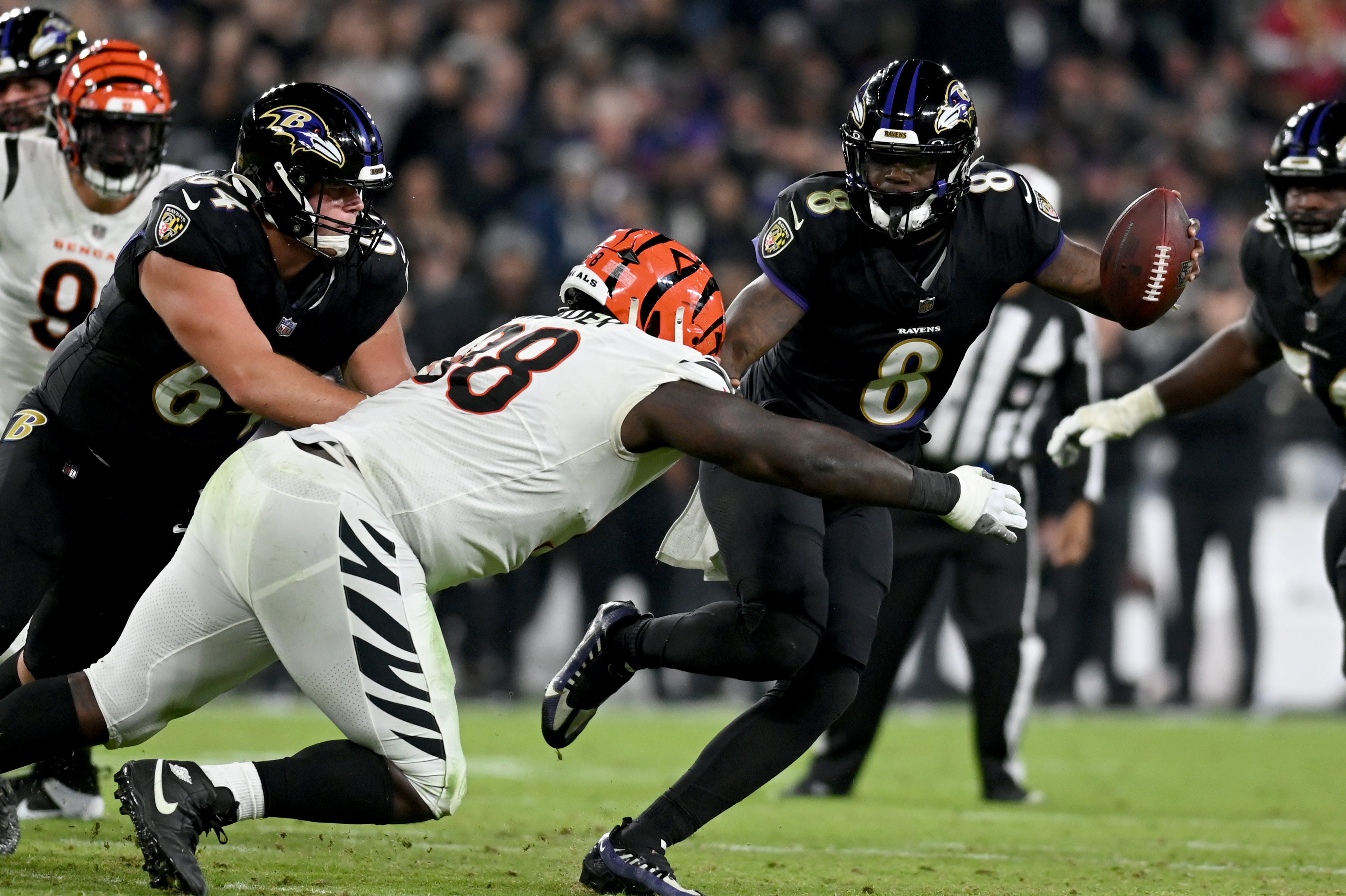Nov 16, 2023; Baltimore, Maryland, USA; Baltimore Ravens quarterback Lamar Jackson (8) stiff arms Cincinnati Bengals defensive tackle DJ Reader (98) during the third quarter at M&T Bank Stadium. Mandatory Credit: Tommy Gilligan-USA TODAY Sports  