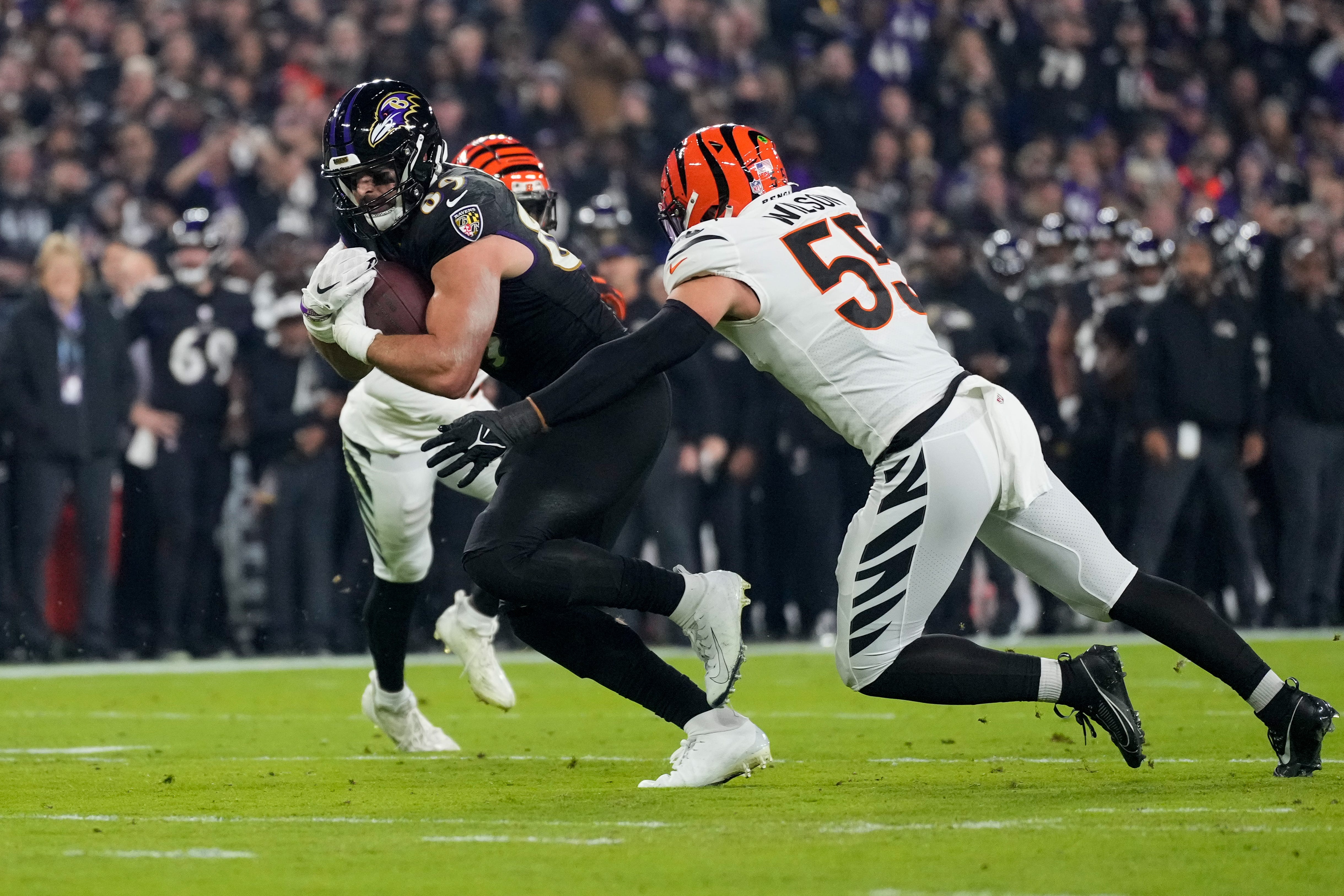Baltimore Ravens tight end Mark Andrews (89) fights a tackle from Cincinnati Bengals linebacker Logan Wilson (55) in the first quarter of the NFL Week 11 game between the Baltimore Ravens and the Cincinnati Bengals at M&T Bank Stadium in Baltimore on Thursday, Nov. 16, 2023.