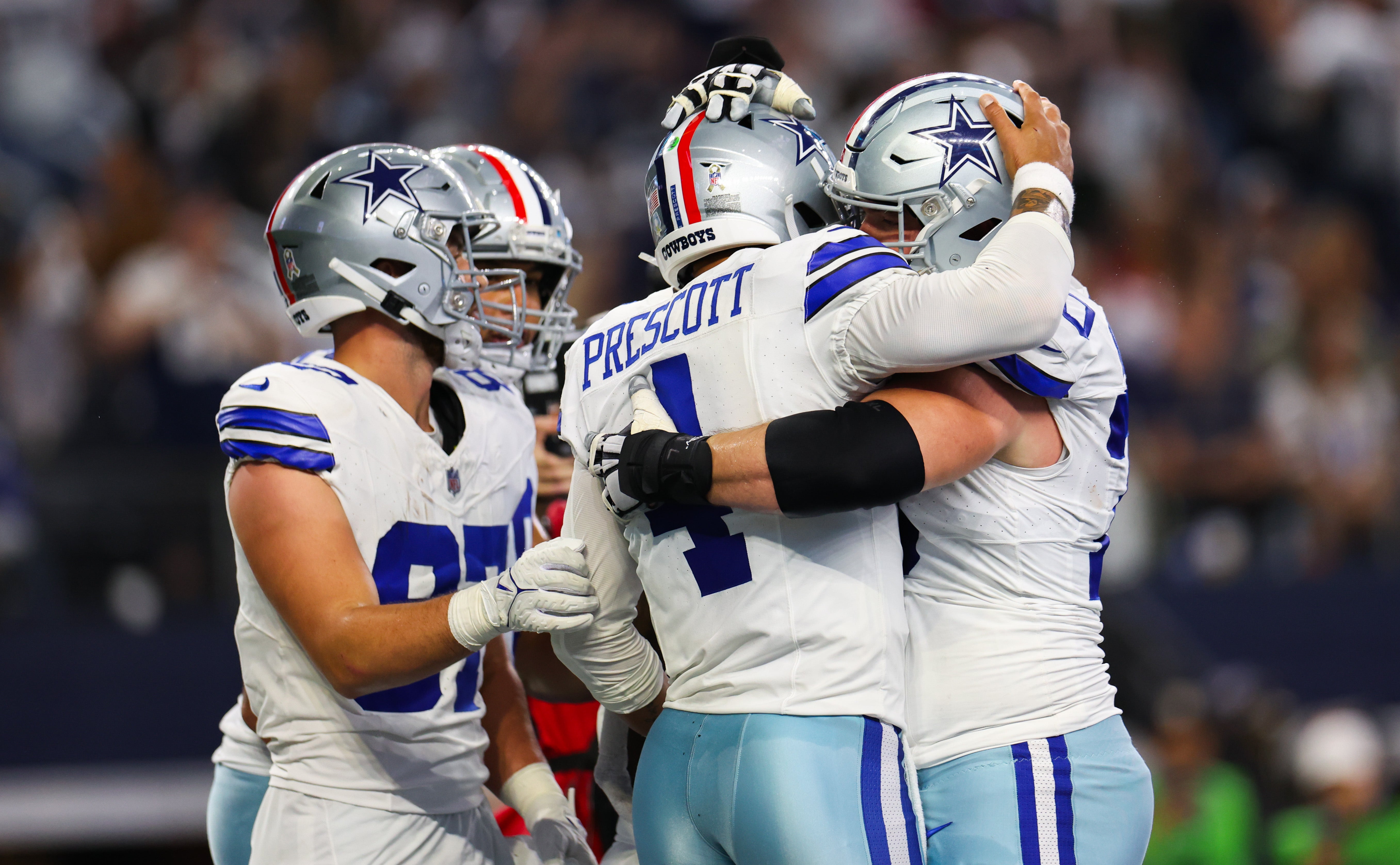 Dallas Cowboys quarterback Dak Prescott (4) celebrates with teammates after scoring a touchdown during the second quarter against the New York Giants at AT&T Stadium.