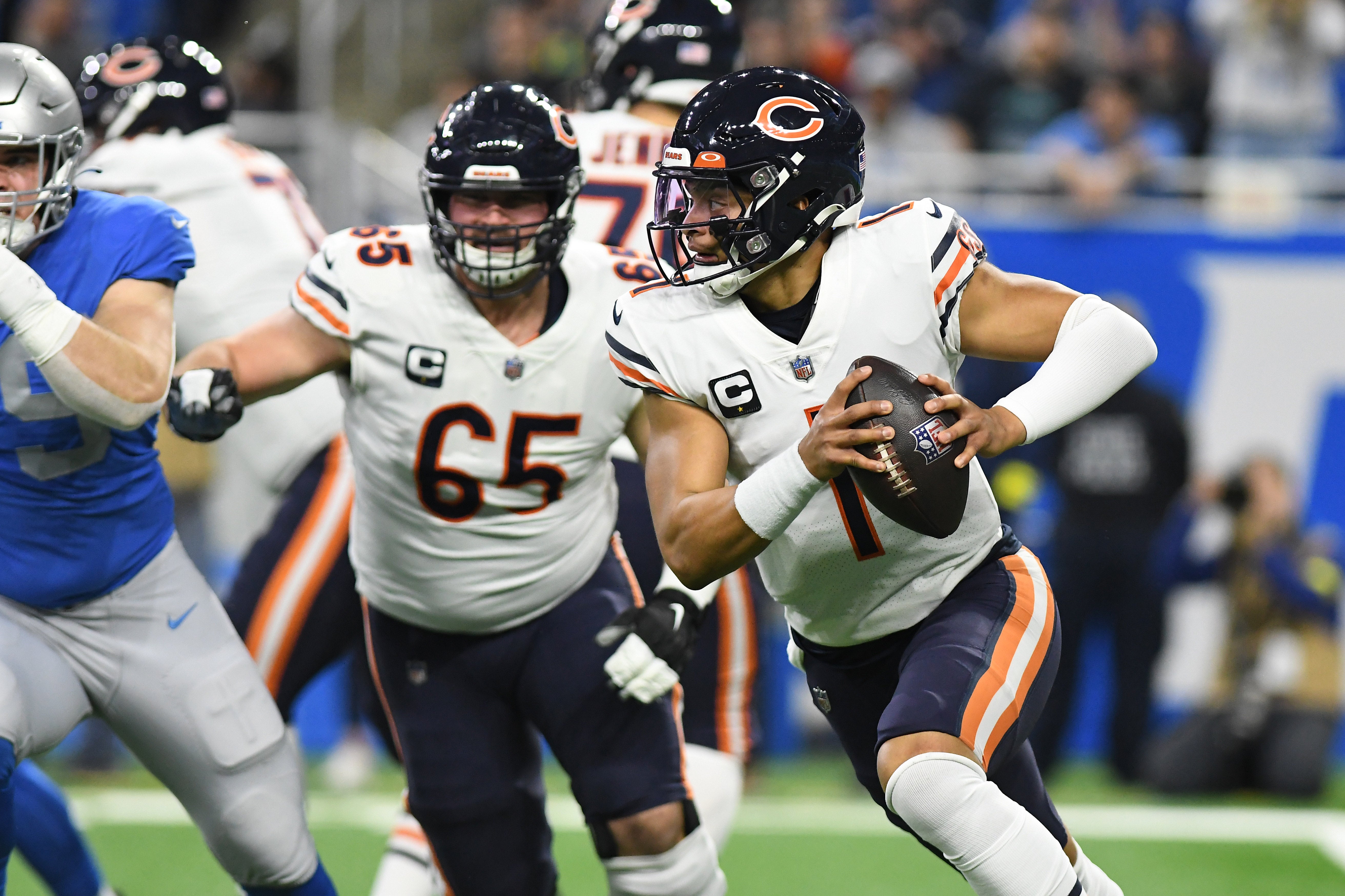 Jan 1, 2023; Detroit, Michigan, USA; Chicago Bears quarterback Justin Fields (1) scrambles out of the pocket against the Detroit Lions in the first quarter at Ford Field. Mandatory Credit: