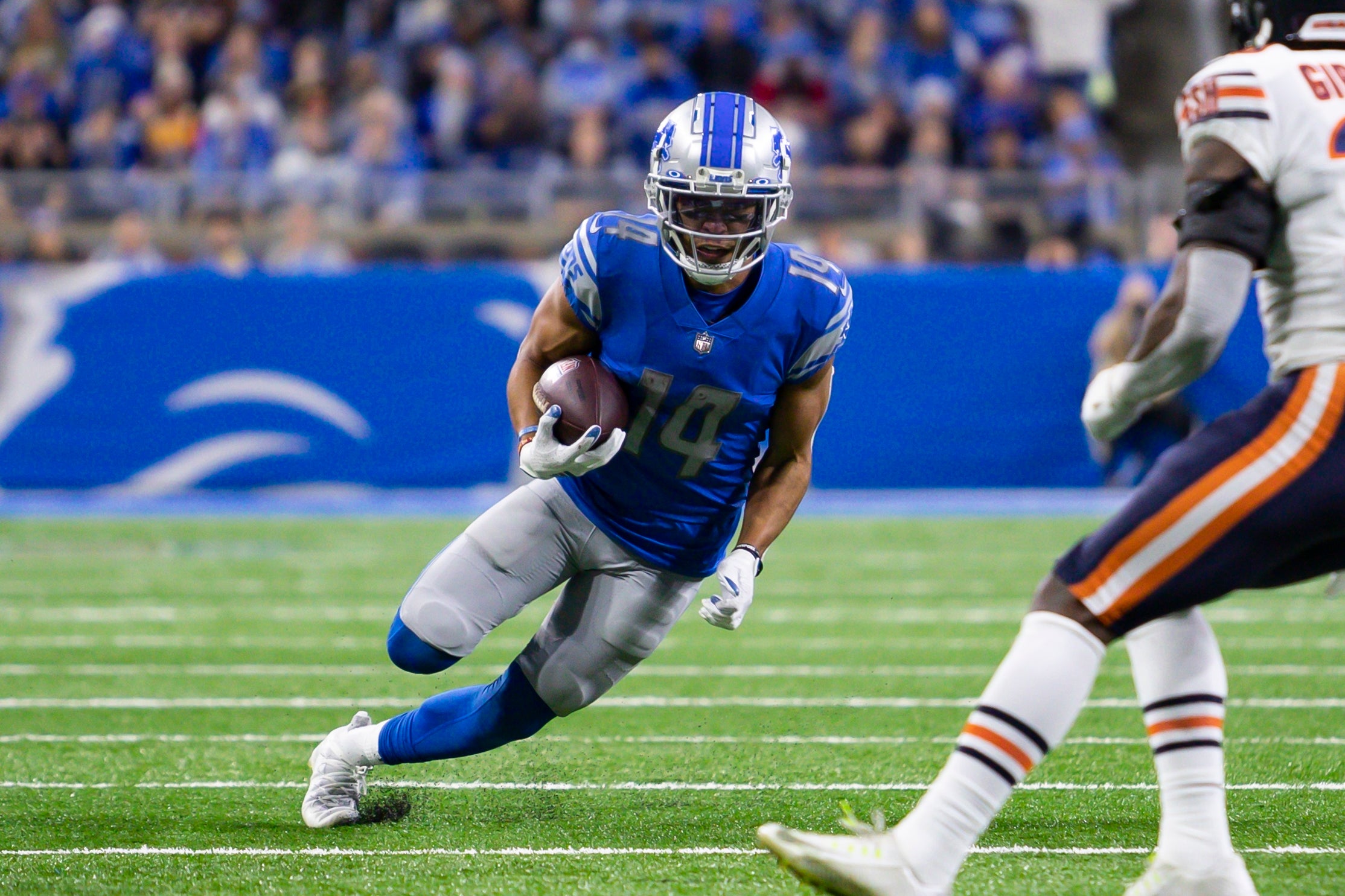 Nov 25, 2021; Detroit, Michigan, USA; Detroit Lions wide receiver Amon-Ra St. Brown (14) runs with the ball during the third quarter against the Chicago Bears at Ford Field.