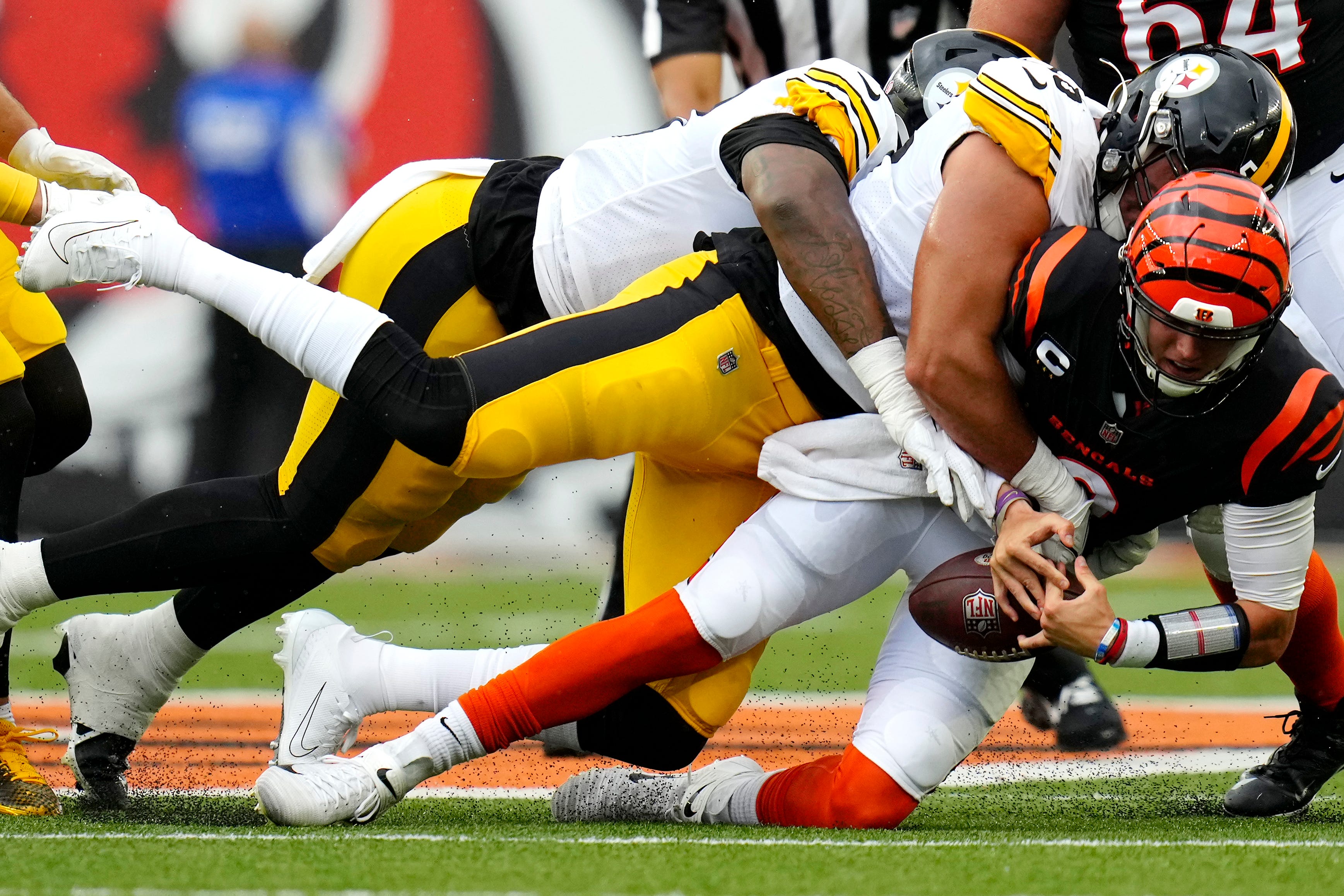 Cincinnati Bengals quarterback Joe Burrow (9) is sacked by Pittsburgh Steelers linebacker Alex Highsmith (56) during the first quarter of a Week 1 NFL football game, Sunday, Sept. 11, 2022, Paycor Stadium in Cincinnati. Nfl Pittsburgh Steelers At Cincinnati Bengals Sept 11 0084