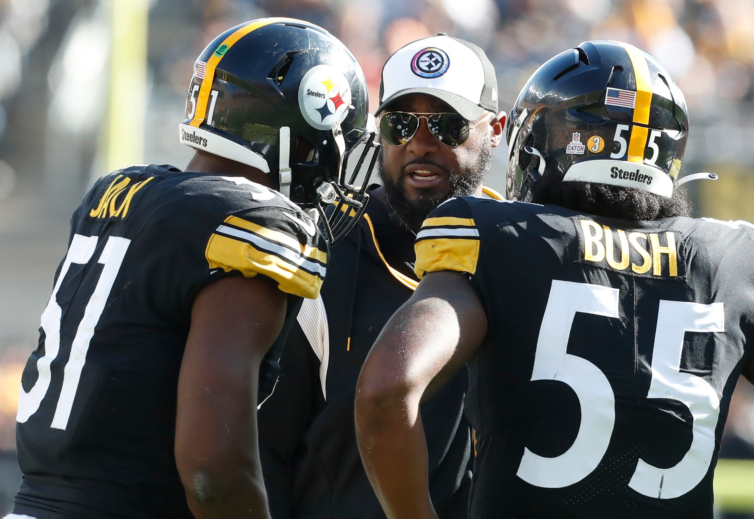 Oct 16, 2022; Pittsburgh, Pennsylvania, USA; Pittsburgh Steelers head coach Mike Tomlin (middle) talks with linebackers linebacker Myles Jack (51) and Devin Bush (55) against the Tampa Bay Buccaneers during the third quarter at Acrisure Stadium. Pittsburgh won 20-18. Mandatory Credit: Charles LeClaire-USA TODAY Sports  