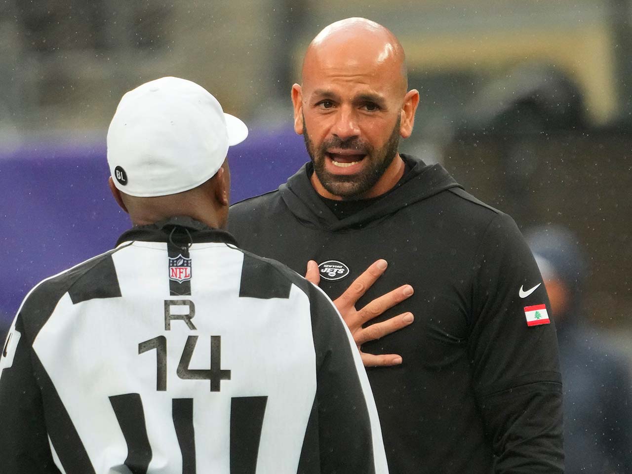 New York Jets head coach Robert Saleh with referee Shawn Smith (14) pre game at MetLife Stadium.