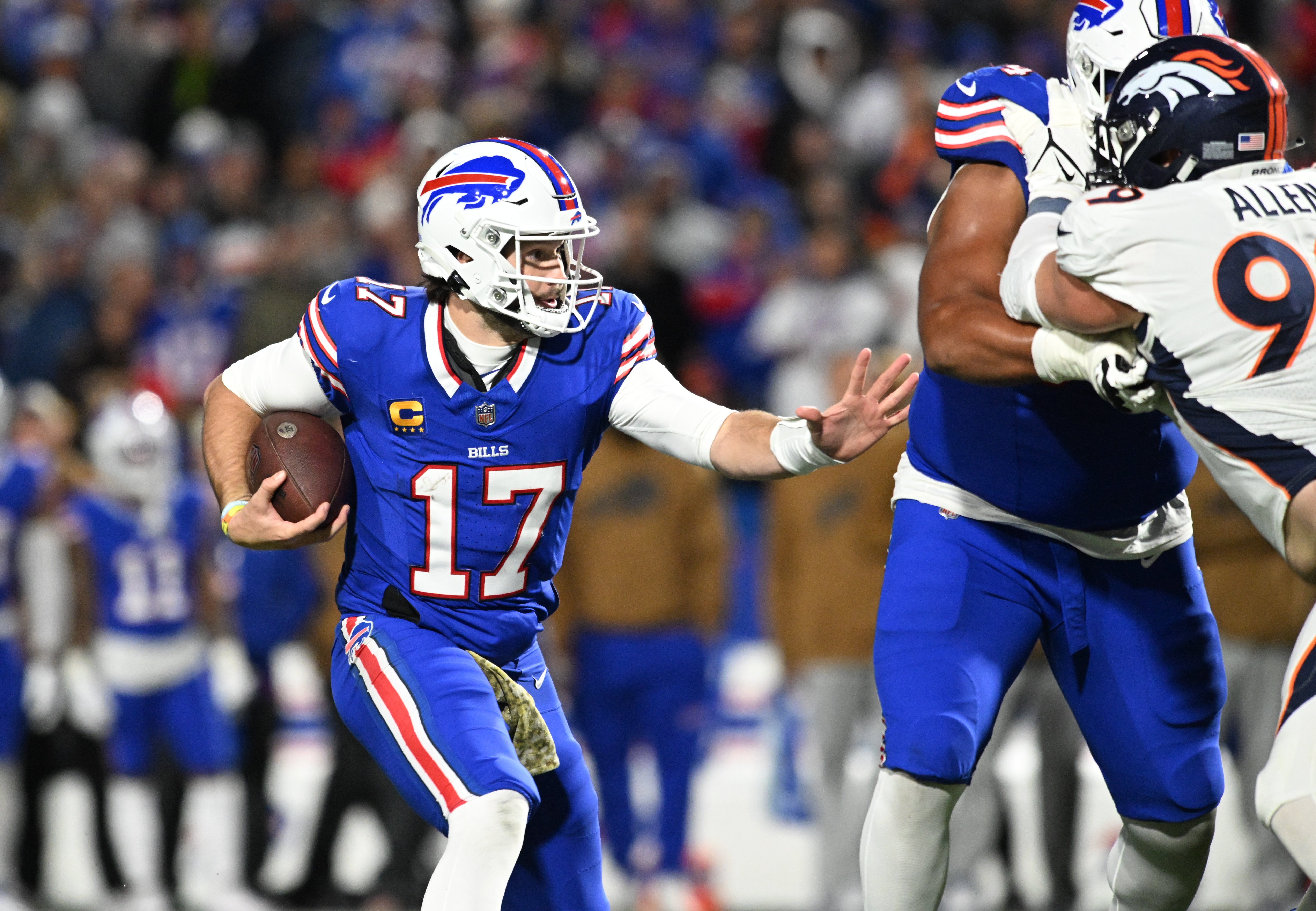 Buffalo Bills quarterback Josh Allen (17) runs the ball against the Denver Broncos in the third quarter at Highmark Stadium.