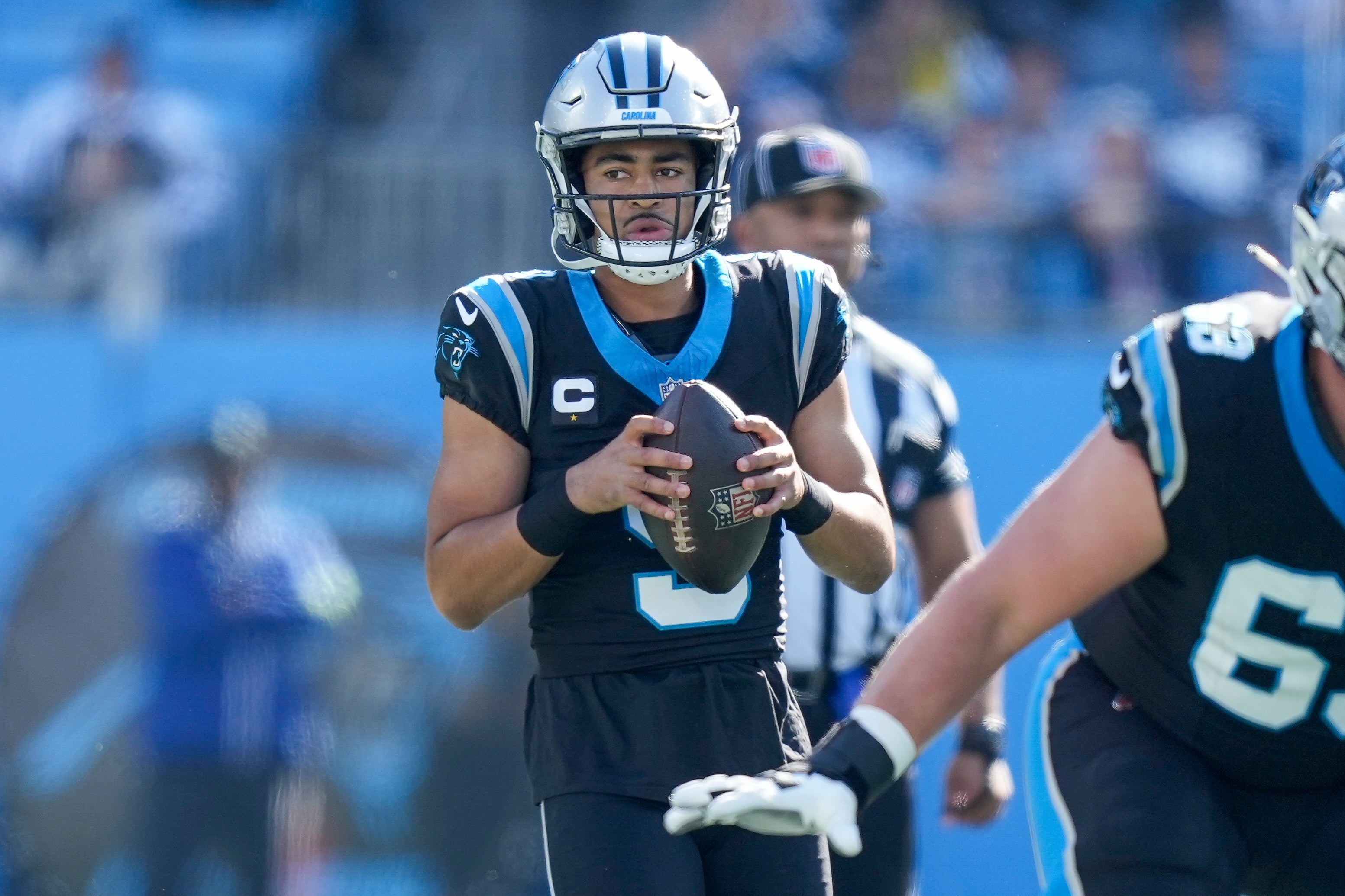 Nov 19, 2023; Charlotte, North Carolina, USA; Carolina Panthers quarterback Bryce Young (9) looks over a defender against the Dallas Cowboys during the first quarter at Bank of America Stadium. Mandatory Credit: Jim Dedmon-USA TODAY Sports