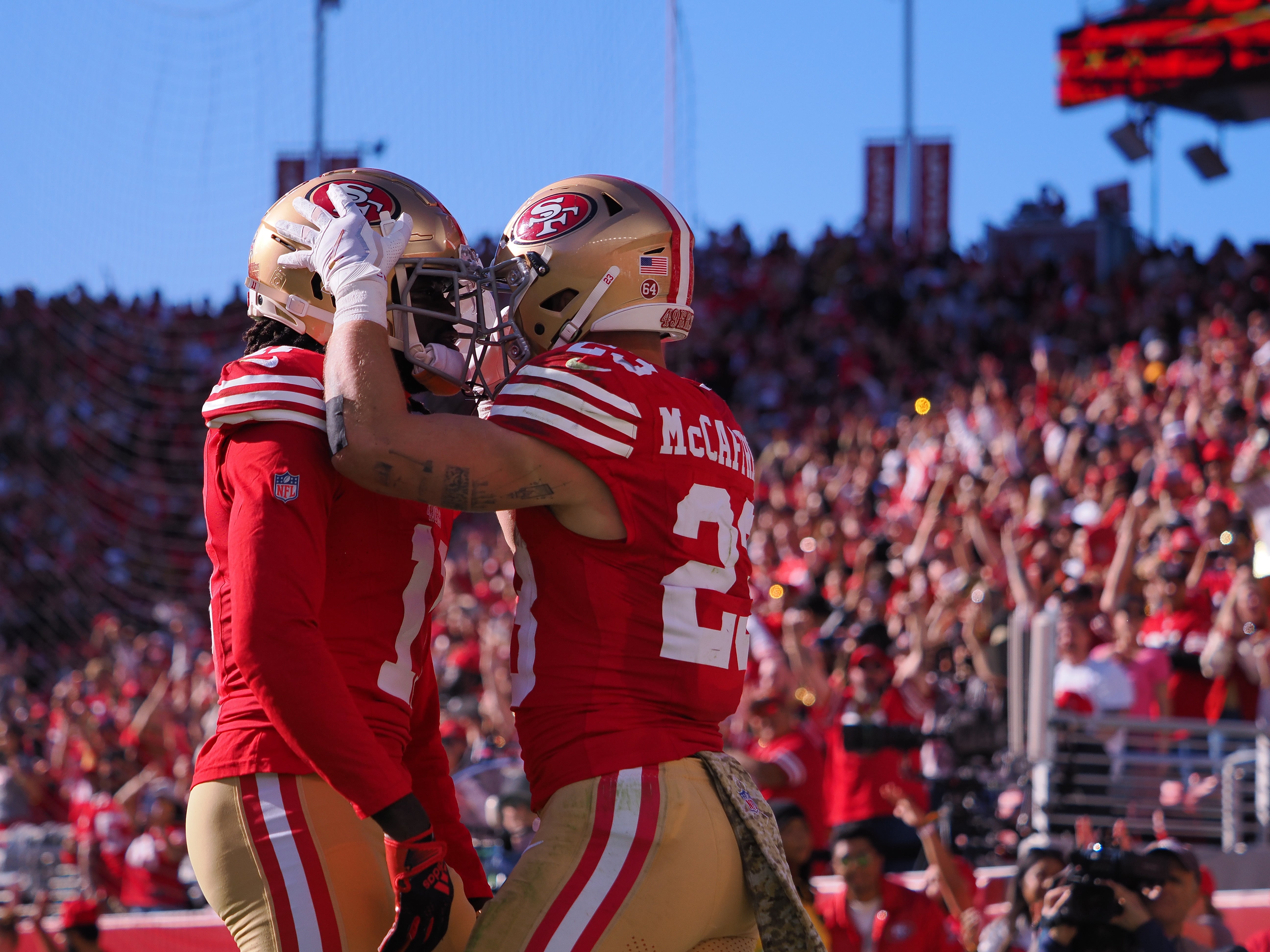Nov 19, 2023; Santa Clara, California, USA; San Francisco 49ers running back Christian McCaffrey (23) celebrates with wide receiver Brandon Aiyuk (11) after scoring a touchdown against the Tampa Bay Buccaneers during the first quarter at Levi's Stadium.