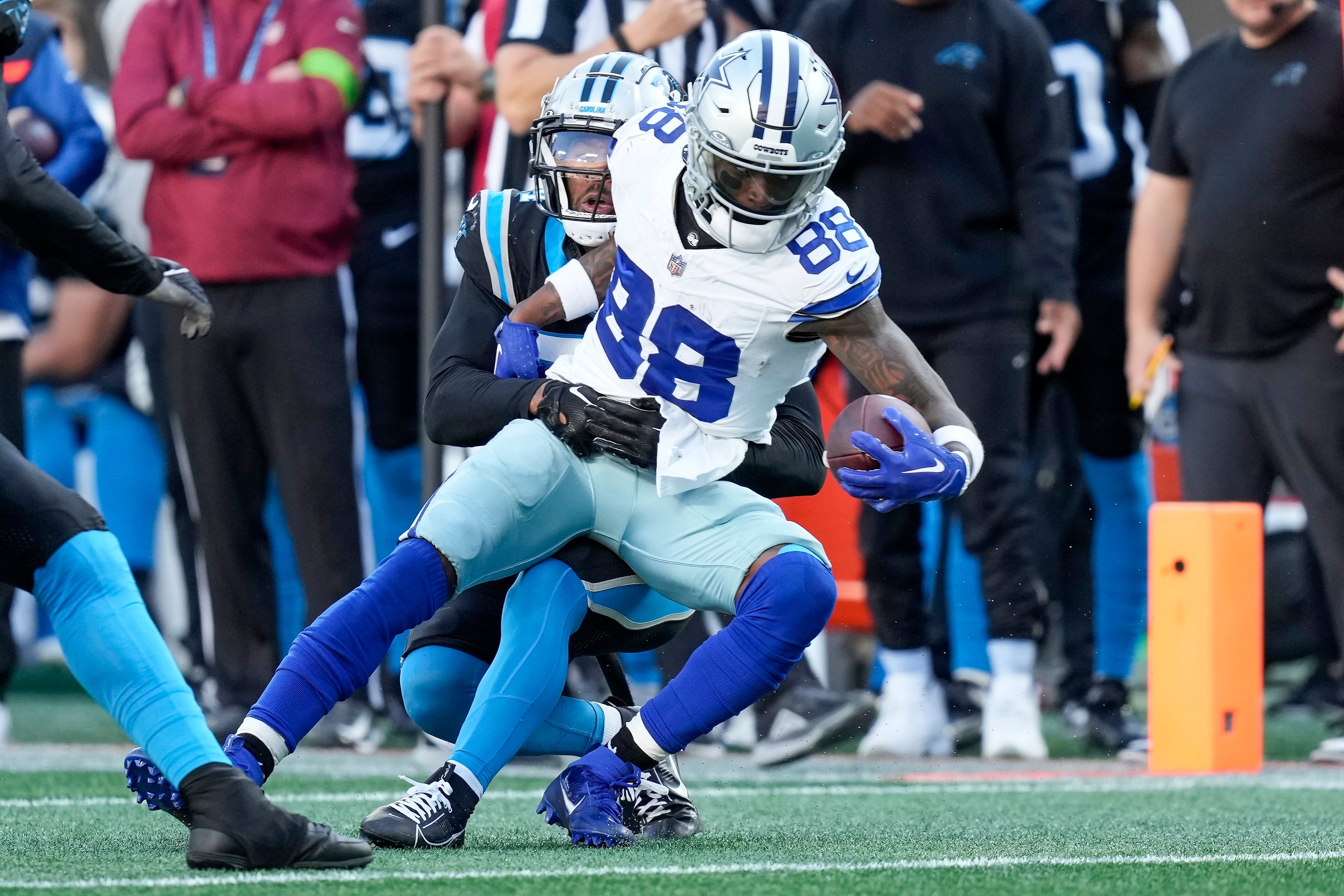 Dallas Cowboys wide receiver CeeDee Lamb (88) is hit as he makes a catch by Carolina Panthers safety Vonn Bell (24) during the second half at Bank of America Stadium.