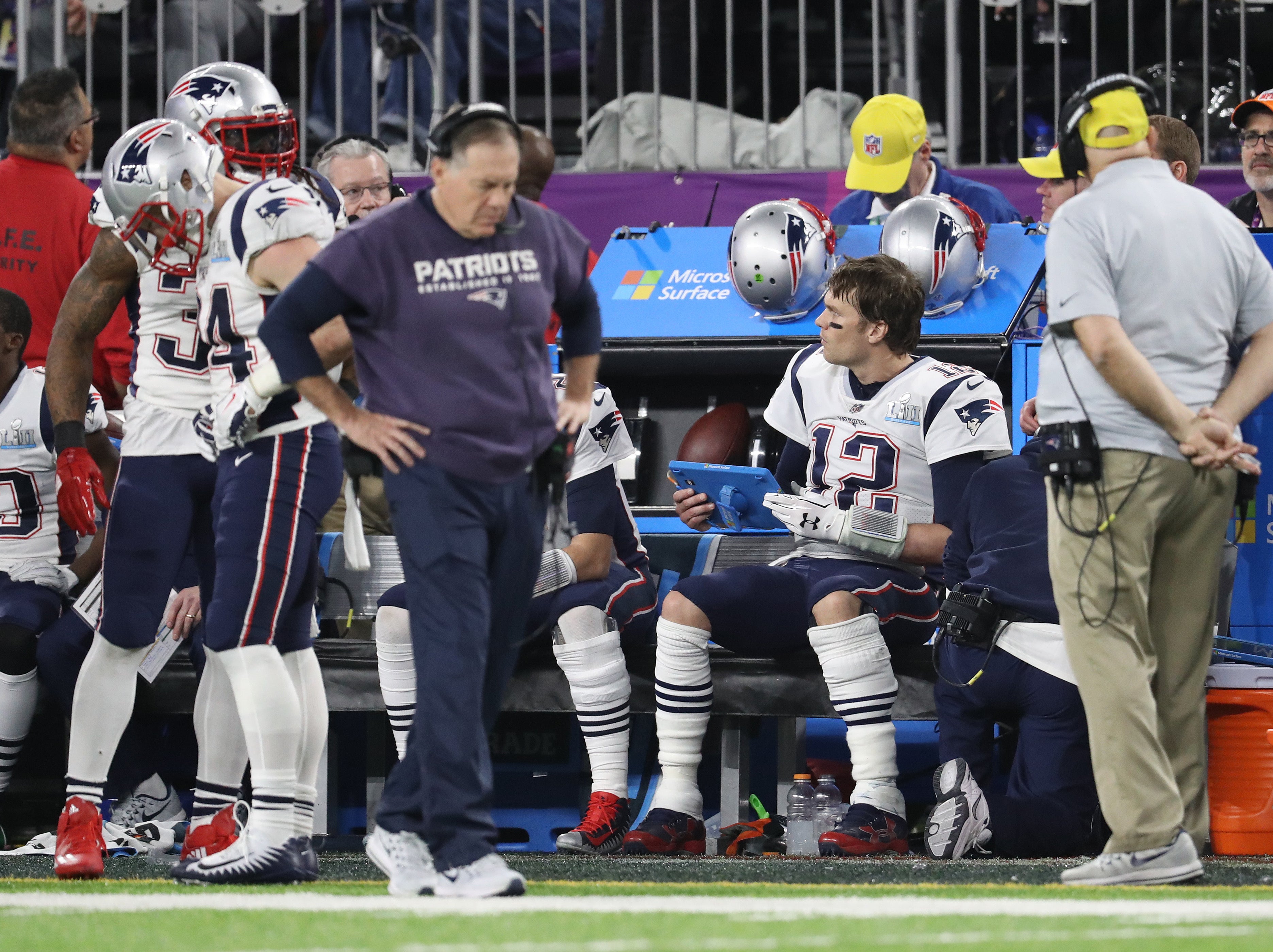 New England Patriots quarterback Tom Brady reviews plays on a tablet as head coach Bill Belichick walks the sidelines during the game against the Philadelphia Eagles in Super Bowl LII at U.S. Bank Stadium
