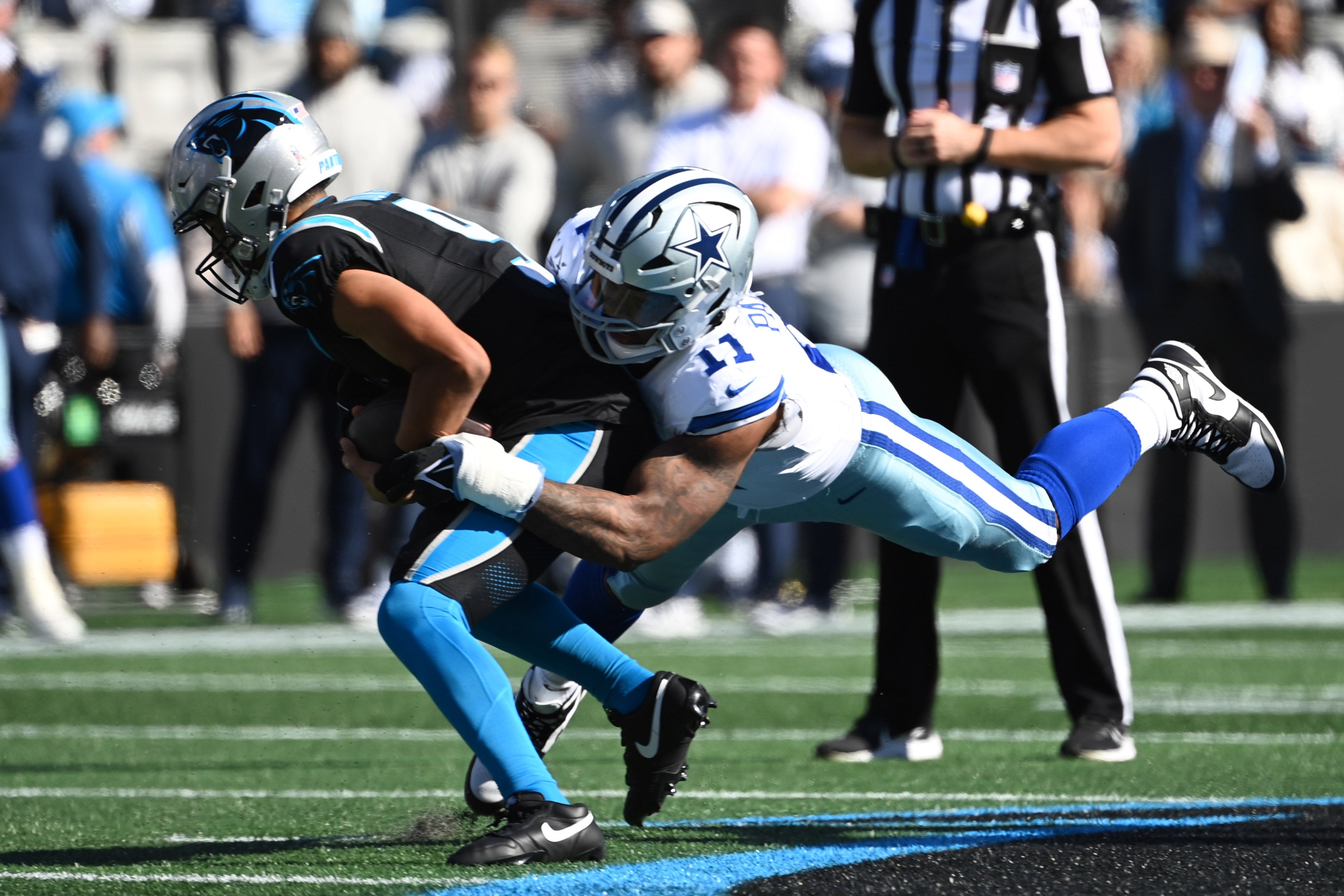 Dallas Cowboys linebacker Micah Parsons (11) sacks Carolina Panthers quarterback Bryce Young (9) in the first quarter at Bank of America Stadium.