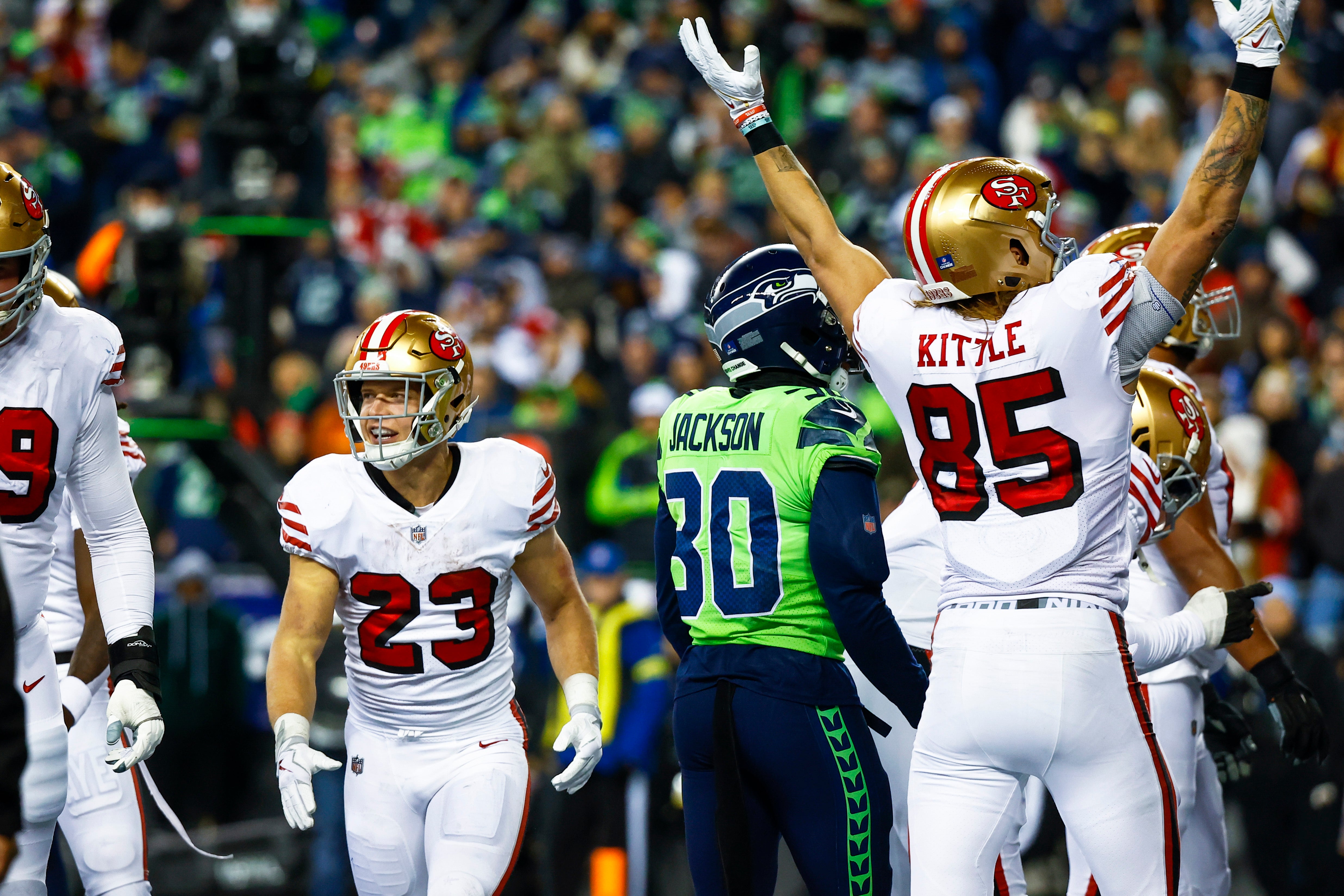Dec 15, 2022; Seattle, Washington, USA; San Francisco 49ers running back Christian McCaffrey (23) celebrates with teammates after rushing for a touchdown against the Seattle Seahawks during the second quarter at Lumen Field.
