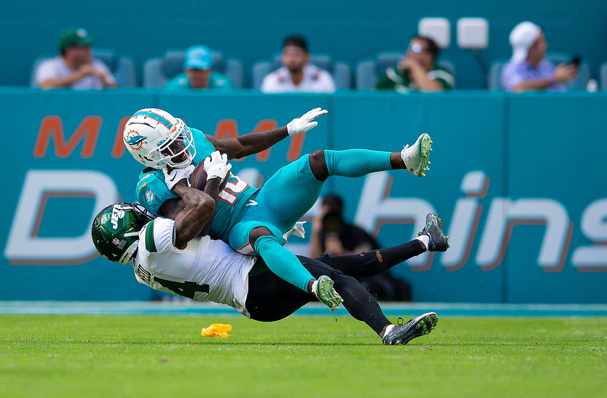Miami Dolphins wide receiver Tyreek Hill (10), gives a New York Jets player a ride during NFL action Sunday January 08, 2023 at Hard Rock Stadium in Miami Gardens.
