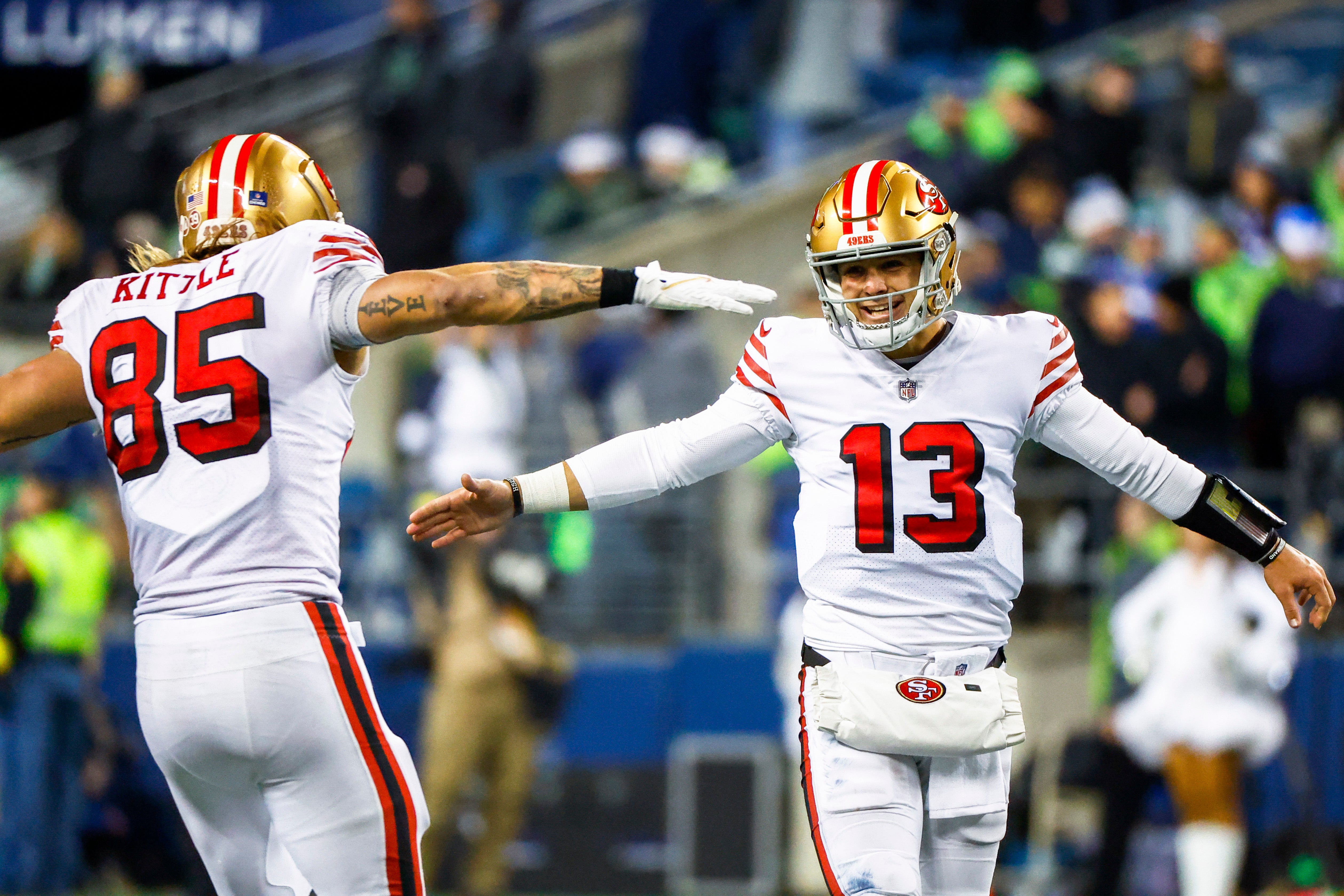 Dec 15, 2022; Seattle, Washington, USA; San Francisco 49ers quarterback Brock Purdy (13) celebrates with tight end George Kittle (85) during the late fourth quarter against the Seattle Seahawks at Lumen Field.