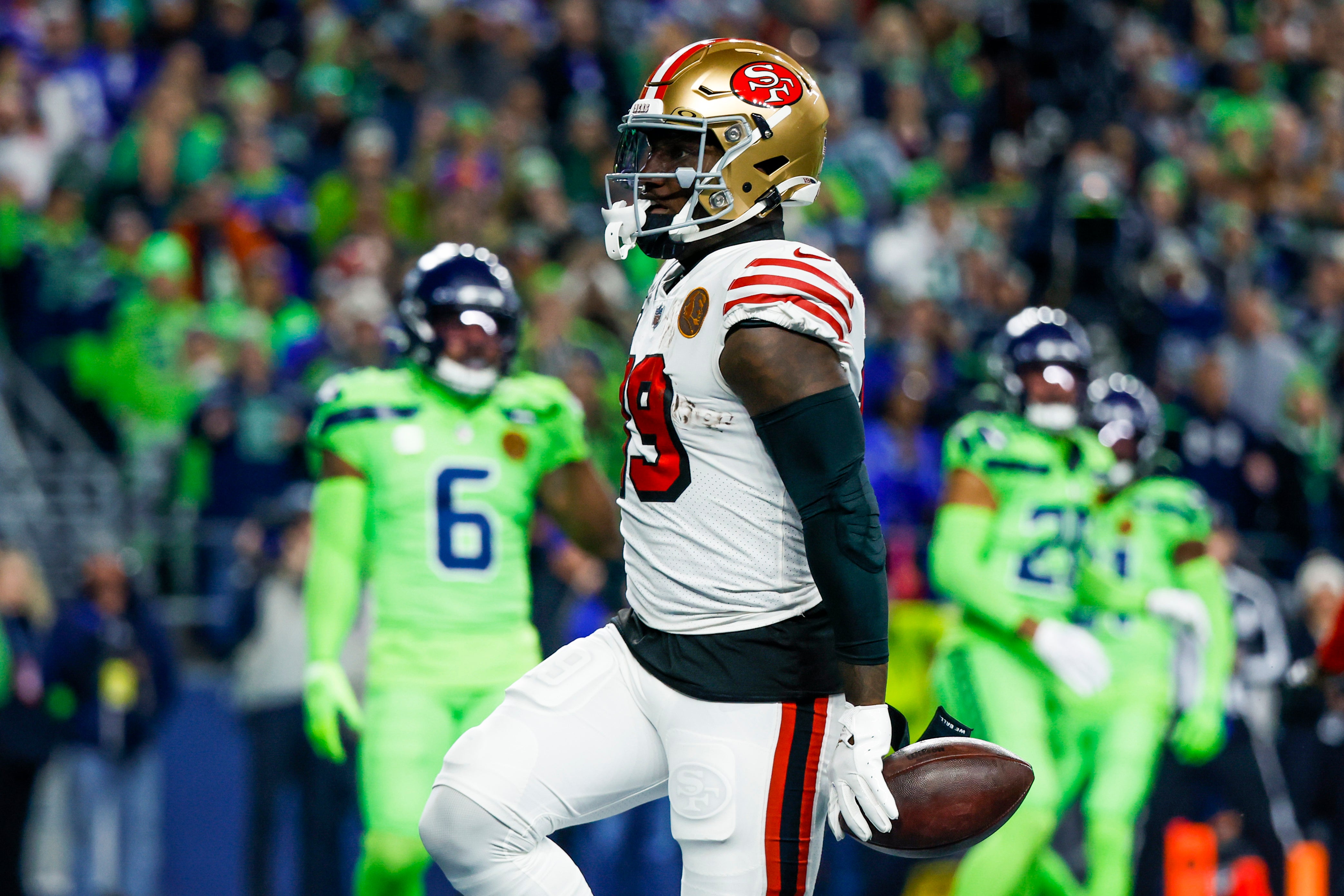 Nov 23, 2023; Seattle, Washington, USA; San Francisco 49ers wide receiver Deebo Samuel (19) celebrates after rushing for a touchdown against the Seattle Seahawks during the first quarter at Lumen Field.