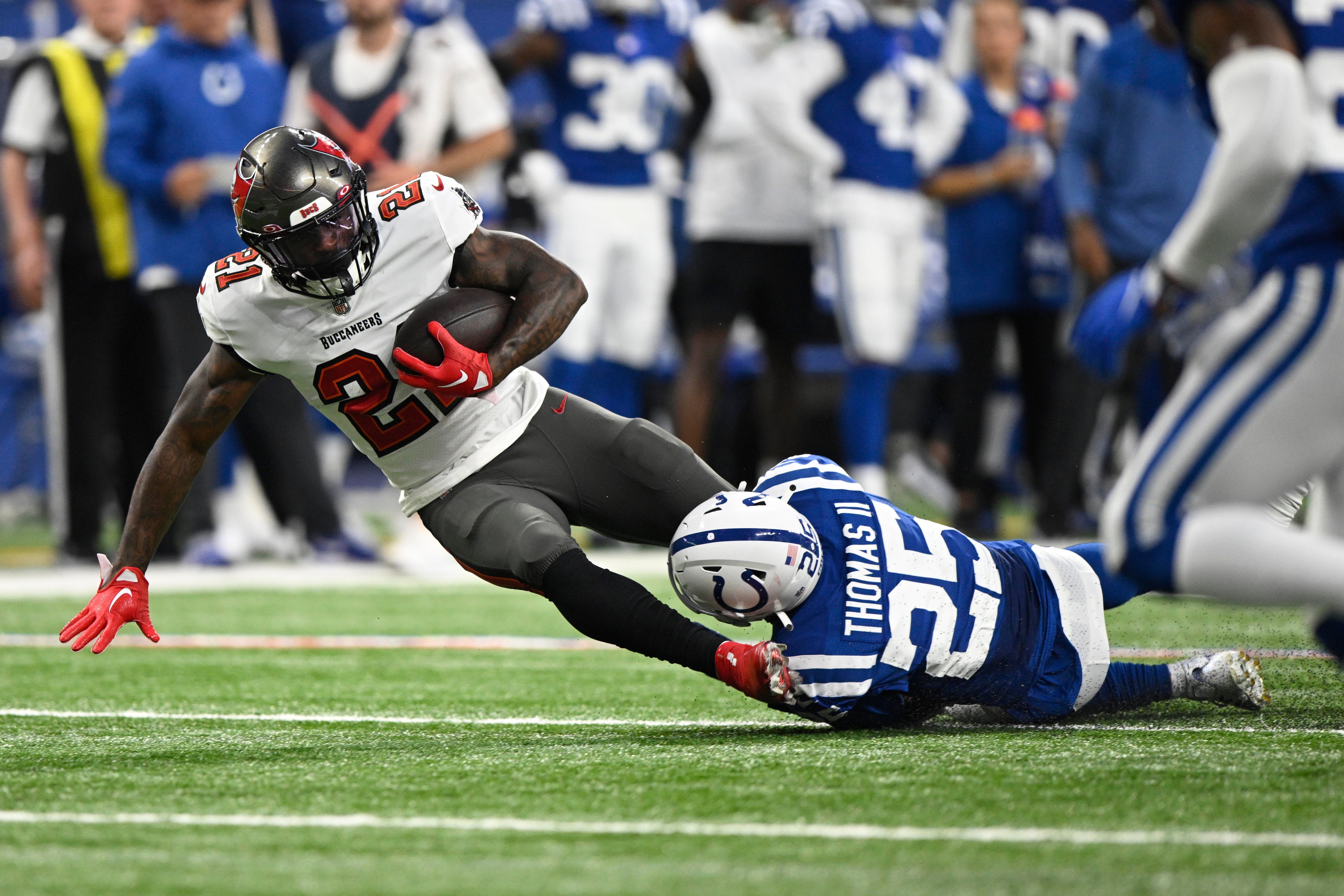 Aug 27, 2022; Indianapolis, Indiana, USA; Tampa Bay Buccaneers running back Ke'Shawn Vaughn (21) is tackled by Indianapolis Colts safety Rodney Thomas II (25) during the second quarter of the game at Lucas Oil Stadium.