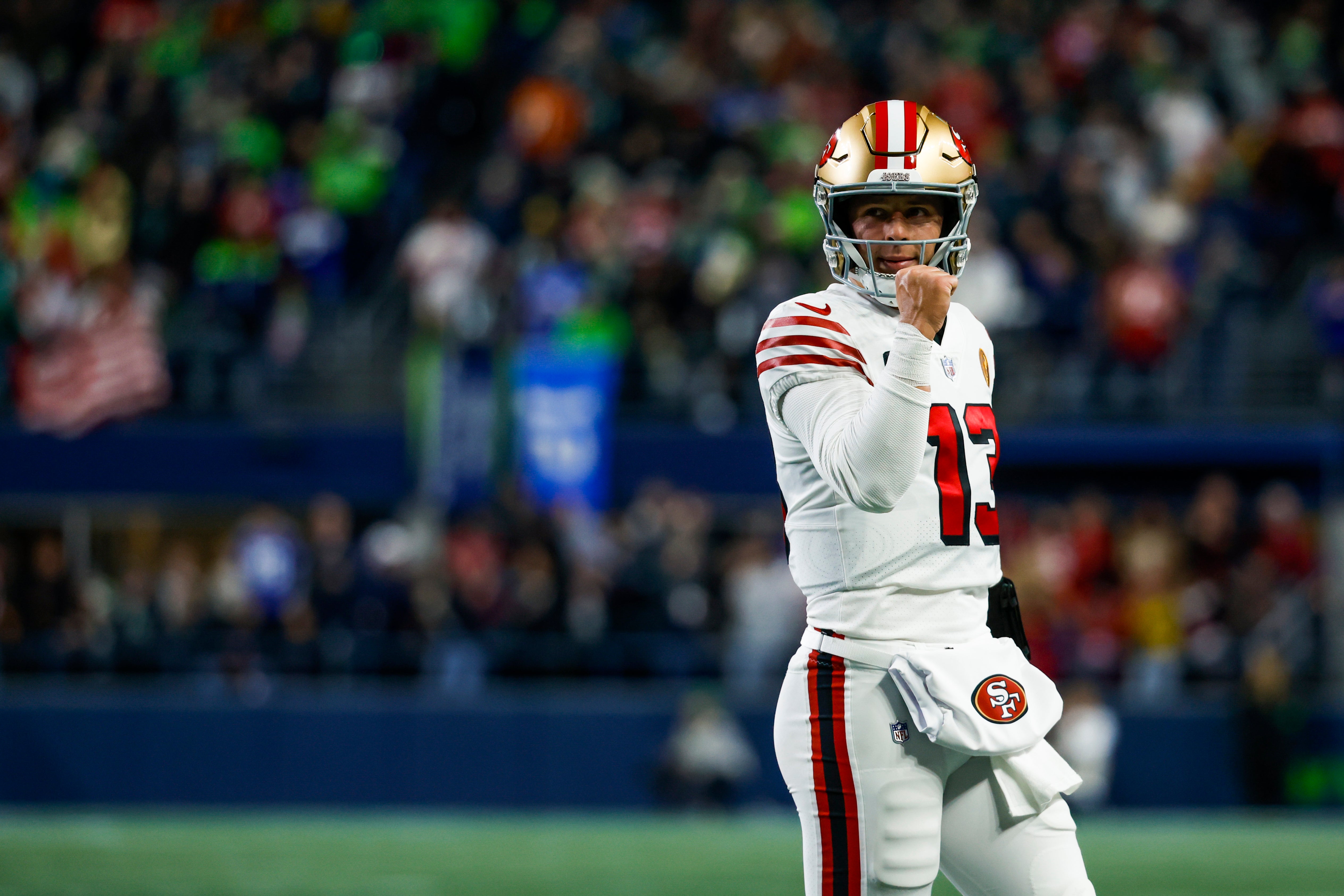 Nov 23, 2023; Seattle, Washington, USA; San Francisco 49ers quarterback Brock Purdy (13) reacts following a rushing touchdown by wide receiver Deebo Samuel (19, not pictured) against the Seattle Seahawks during the first quarter at Lumen Field.