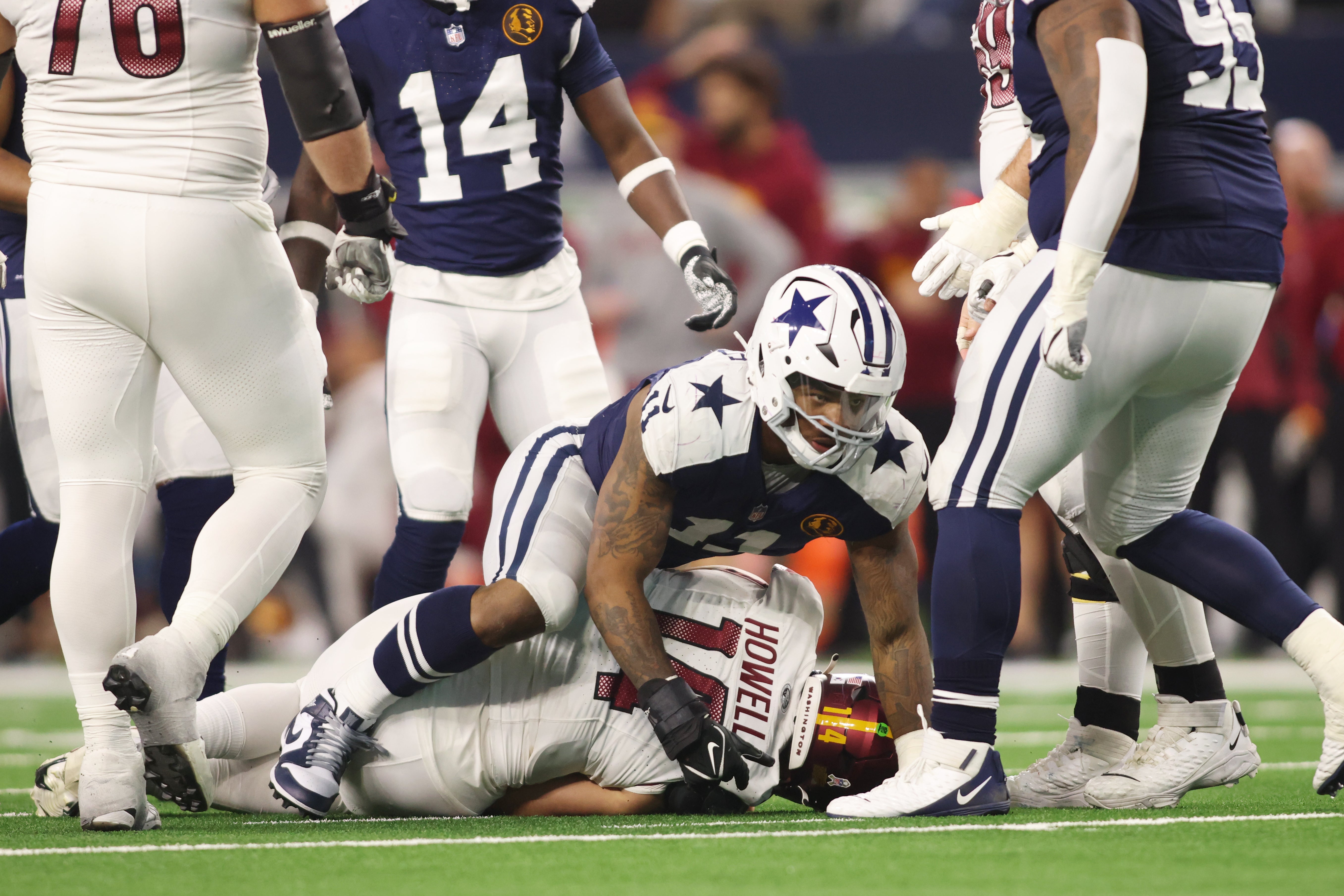 Dallas Cowboys linebacker Micah Parsons (11) sacks Washington Commanders quarterback Sam Howell (14) in the fourth quarter at AT&T Stadium.