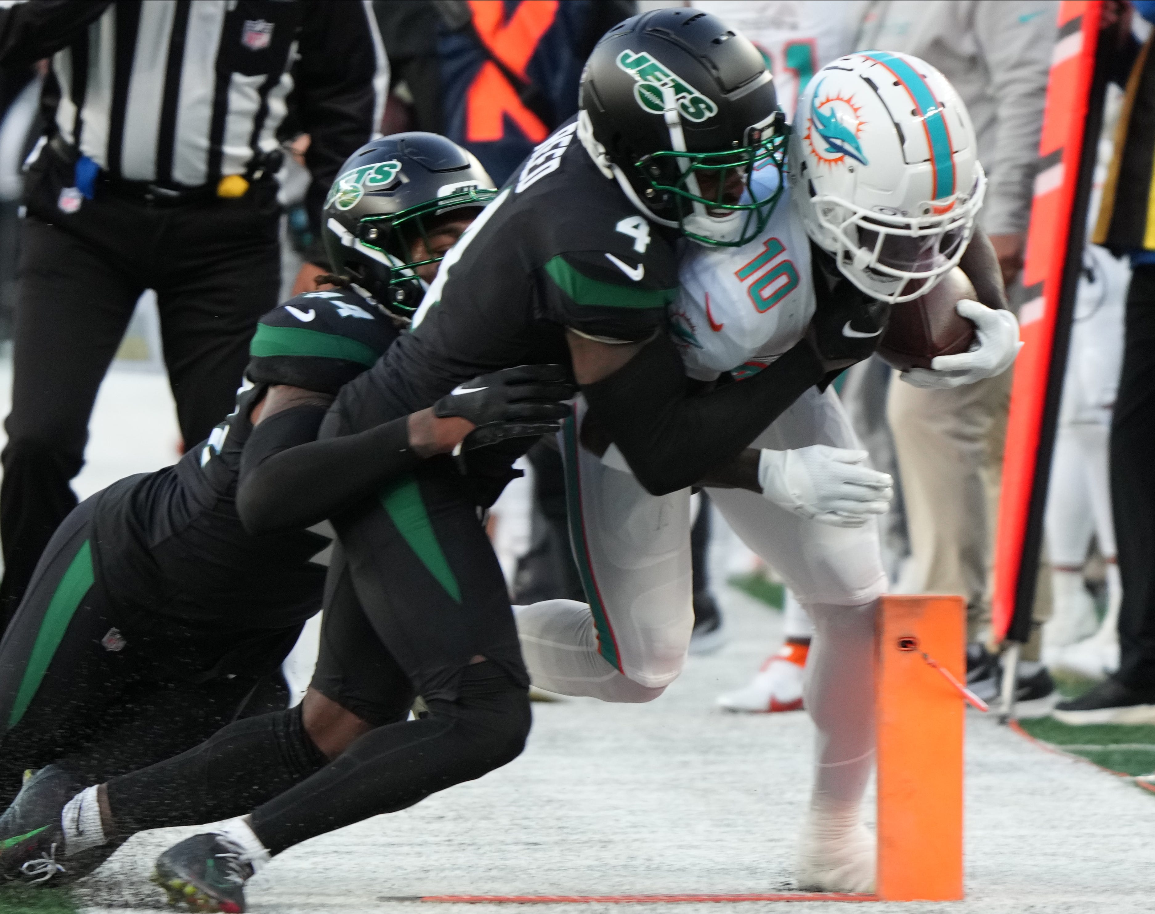 D.J. Reed of the Jets tackles Tyreek Hill of Miami in the first half as the Miami Dolphins defeated the NY Jets 34-13 at MetLife Stadium on November 24, 2023 in East Rutherford, NJ to play in the first Black Friday NFL game.