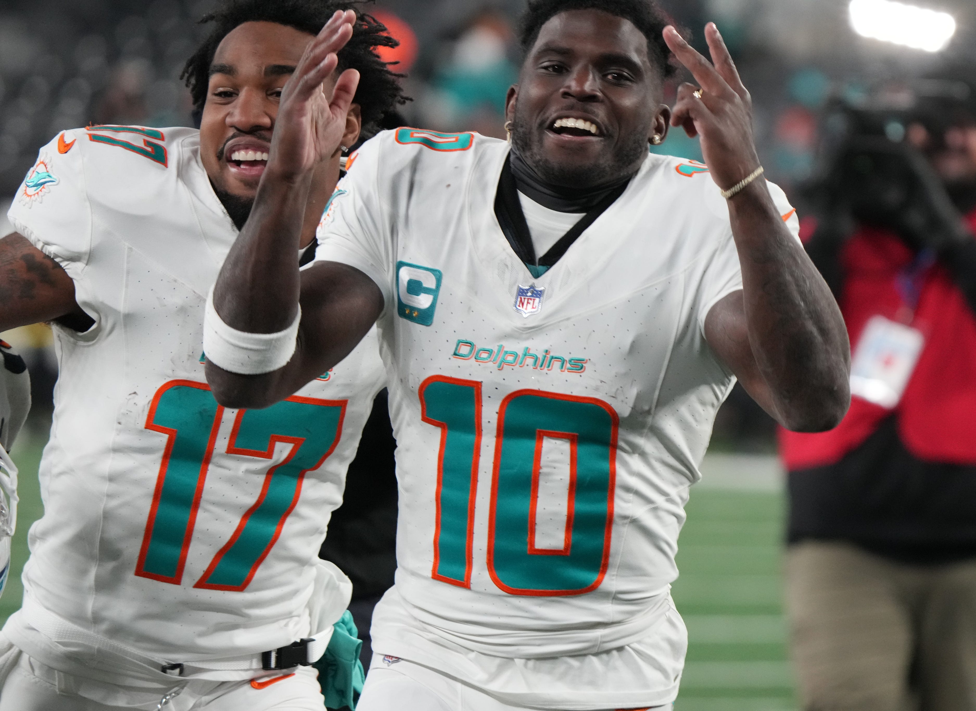 Miami's Jaylen Waddle and Tyreek Hill celebrate the Dolphins' win against the New York Jets.