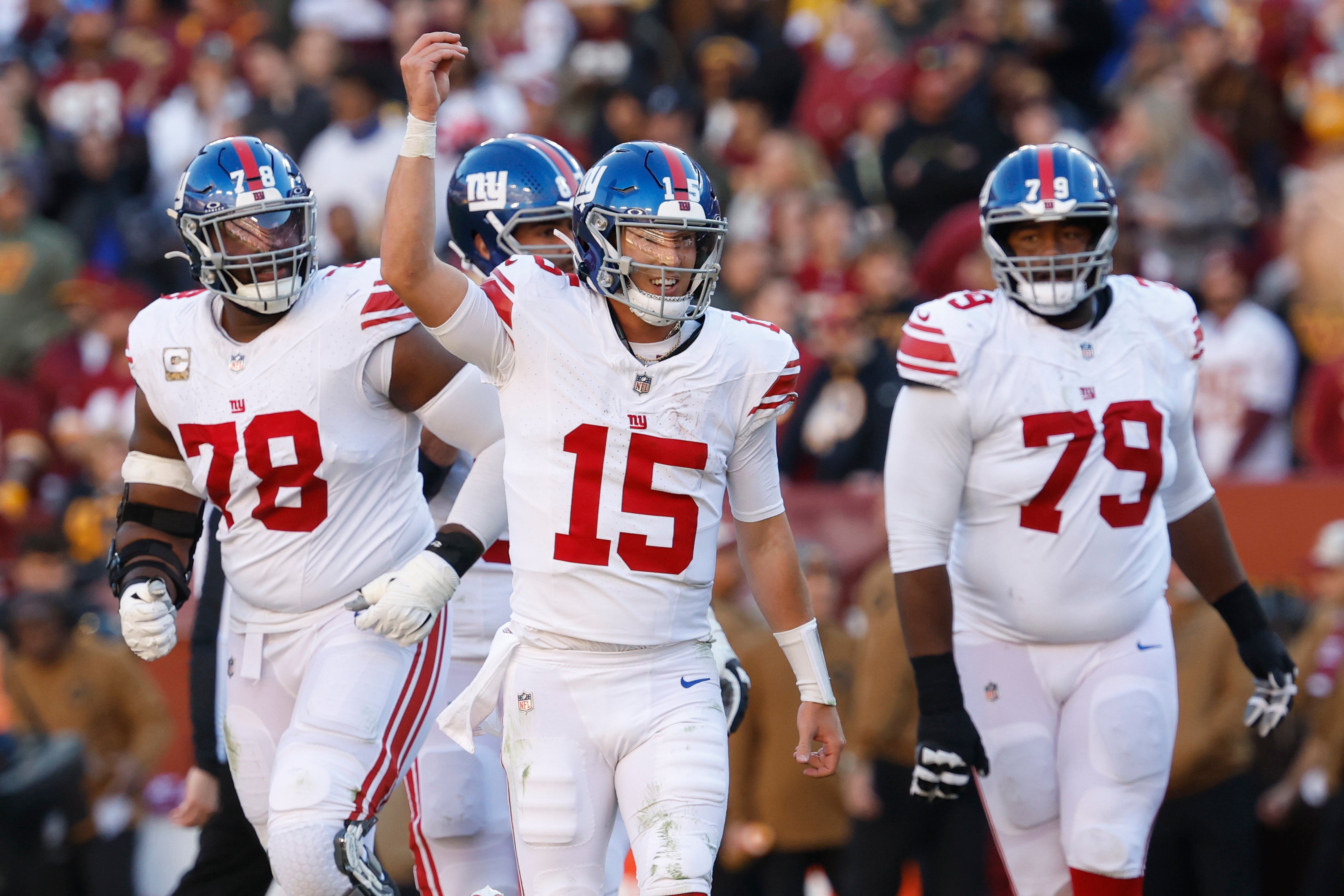 New York Giants quarterback Tommy DeVito celebrates after throwing a touchdown pass against the Washington Commanders during the second quarter at FedExField