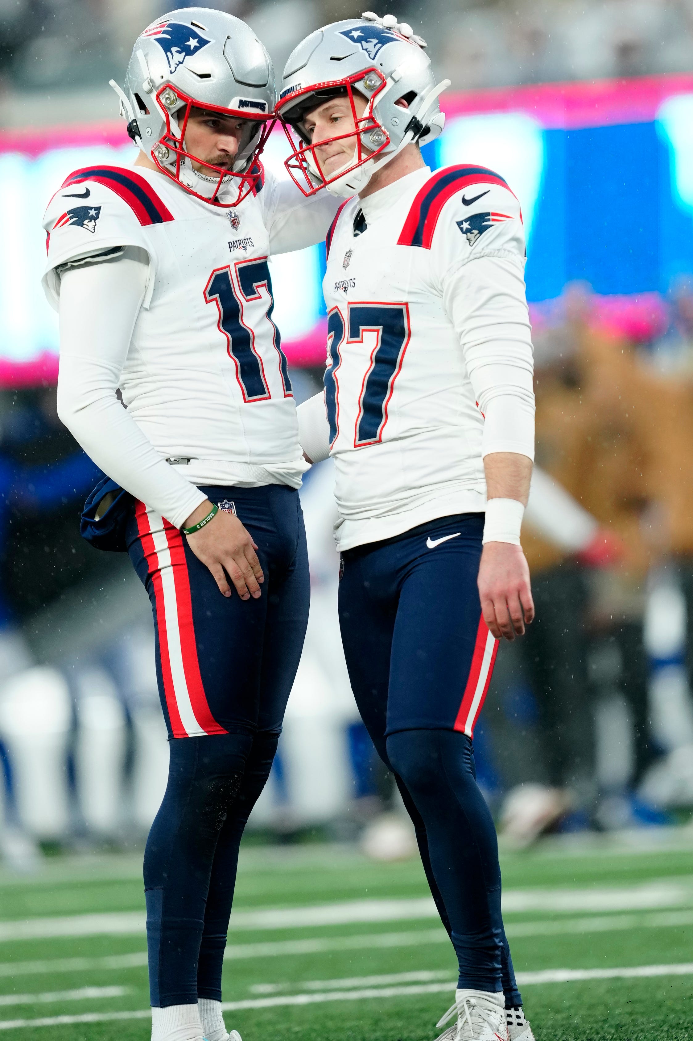 New England Patriots punter Bryce Baringer consoles New England Patriots place kicker Chad Ryland who missed a field goal attempt with five seconds left in the game. The field goal would have tied the game