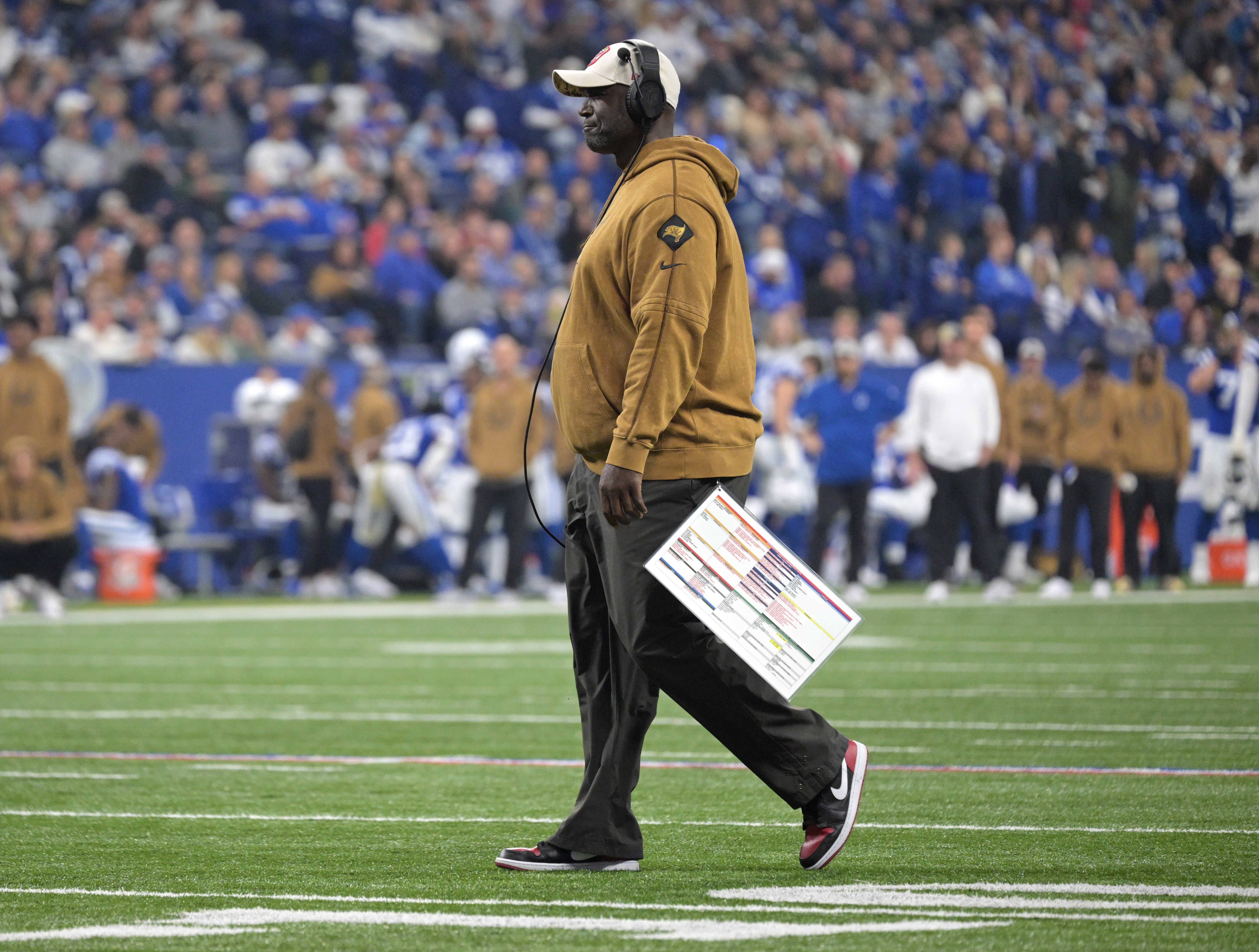 Nov 26, 2023; Indianapolis, Indiana, USA; Tampa Bay Buccaneers head coach Todd Bowles walks onto the field to check on an injured player during the first quarter against the Indianapolis Colts at Lucas Oil Stadium. Mandatory Credit: Marc Lebryk-USA TODAY Sports