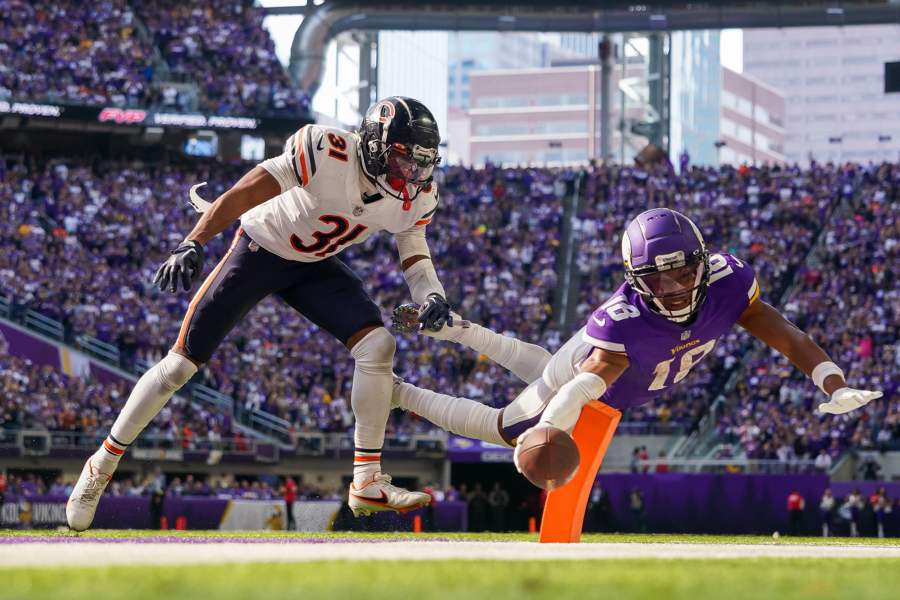 Oct 9, 2022; Minneapolis, Minnesota, USA; Minnesota Vikings wide receiver Justin Jefferson (18) dives for a two-point conversion against the Chicago Bears cornerback Jaylon Jones (31) in the fourth quarter at U.S. Bank Stadium.