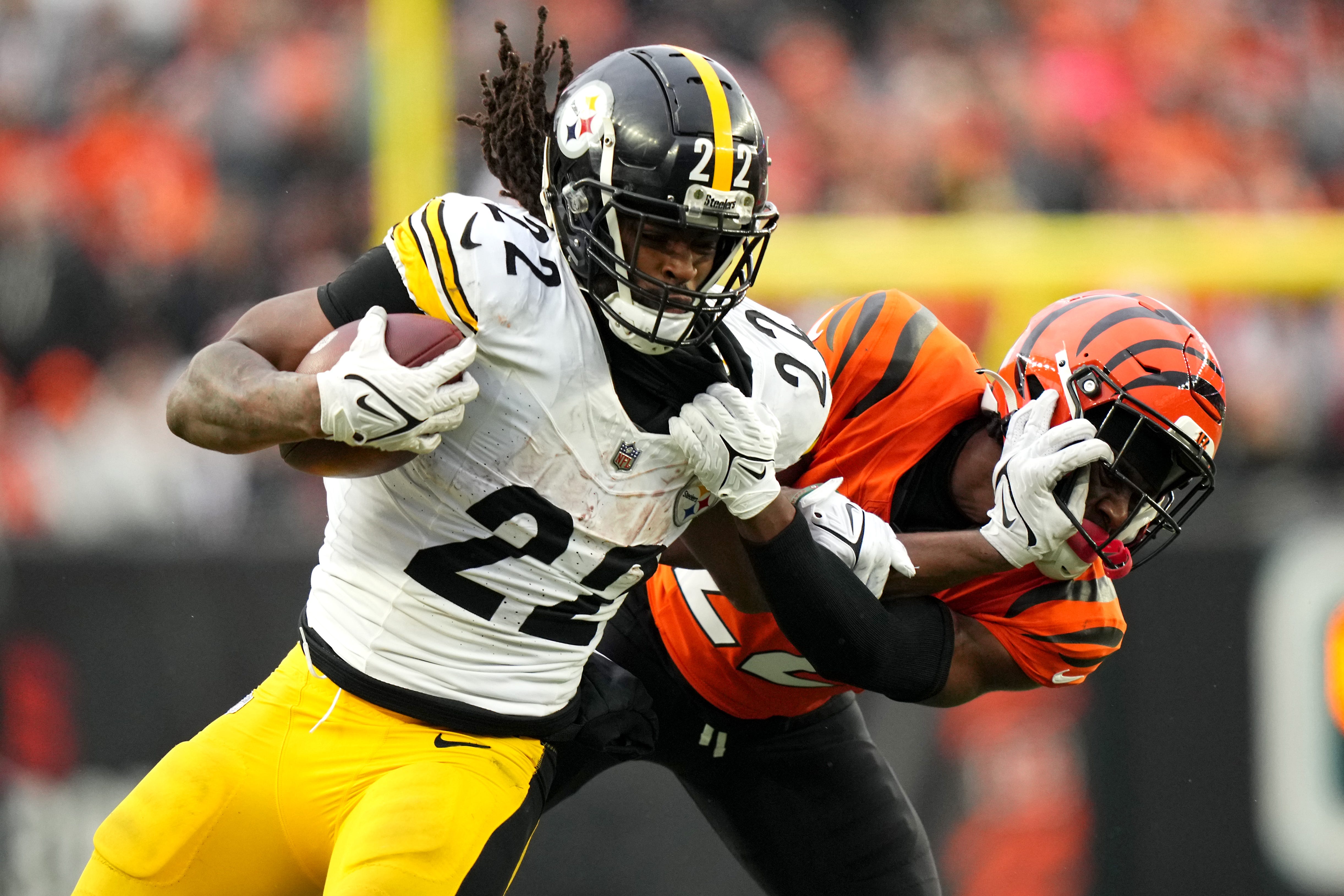 Pittsburgh Steelers running back Najee Harris (22) stiff arms Cincinnati Bengals cornerback Chidobe Awuzie (22) on a carry in the fourth quarter of a Week 12 NFL football game between the Pittsburgh Steelers and the Cincinnati Bengals, Sunday, Nov. 26, 2023, at Paycor Stadium.
