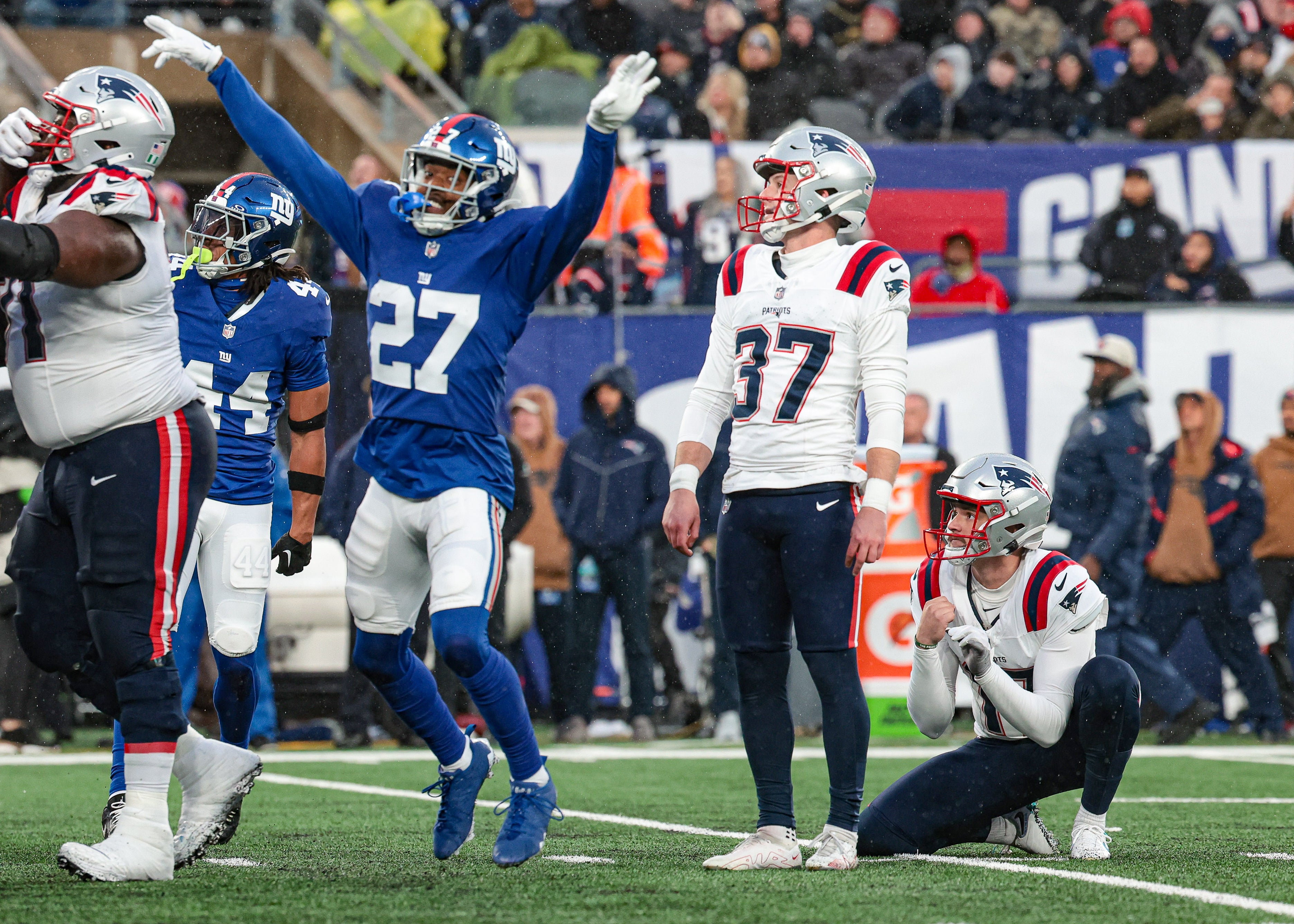 New England Patriots place kicker Chad Ryland reacts after missing a field goal during the fourth quarter as New York Giants safety Jason Pinnock celebrates at MetLife Stadium.