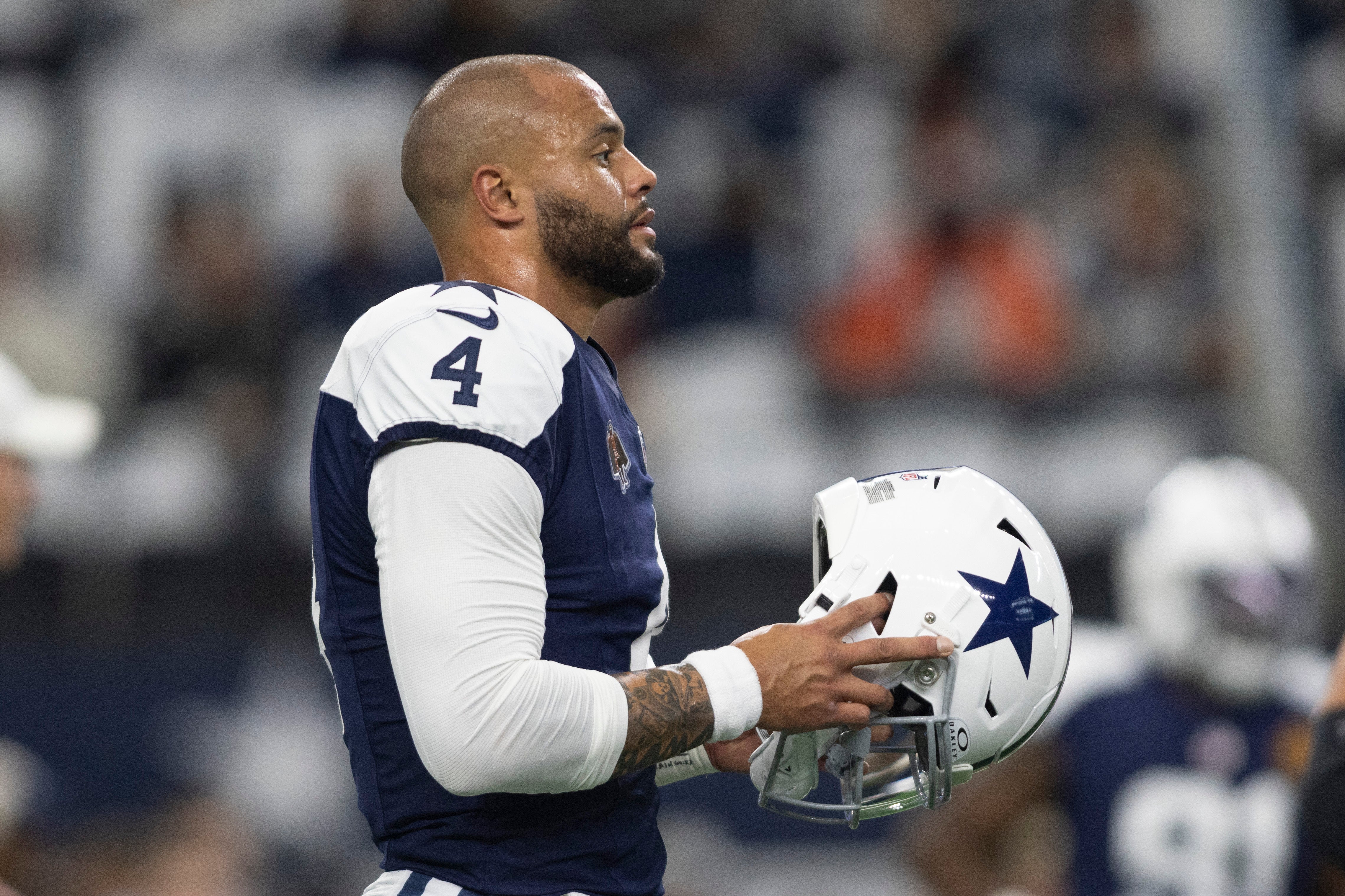 Dallas Cowboys quarterback Dak Prescott (4) walks on the field before the game against the Washington Commanders at AT&T Stadium.