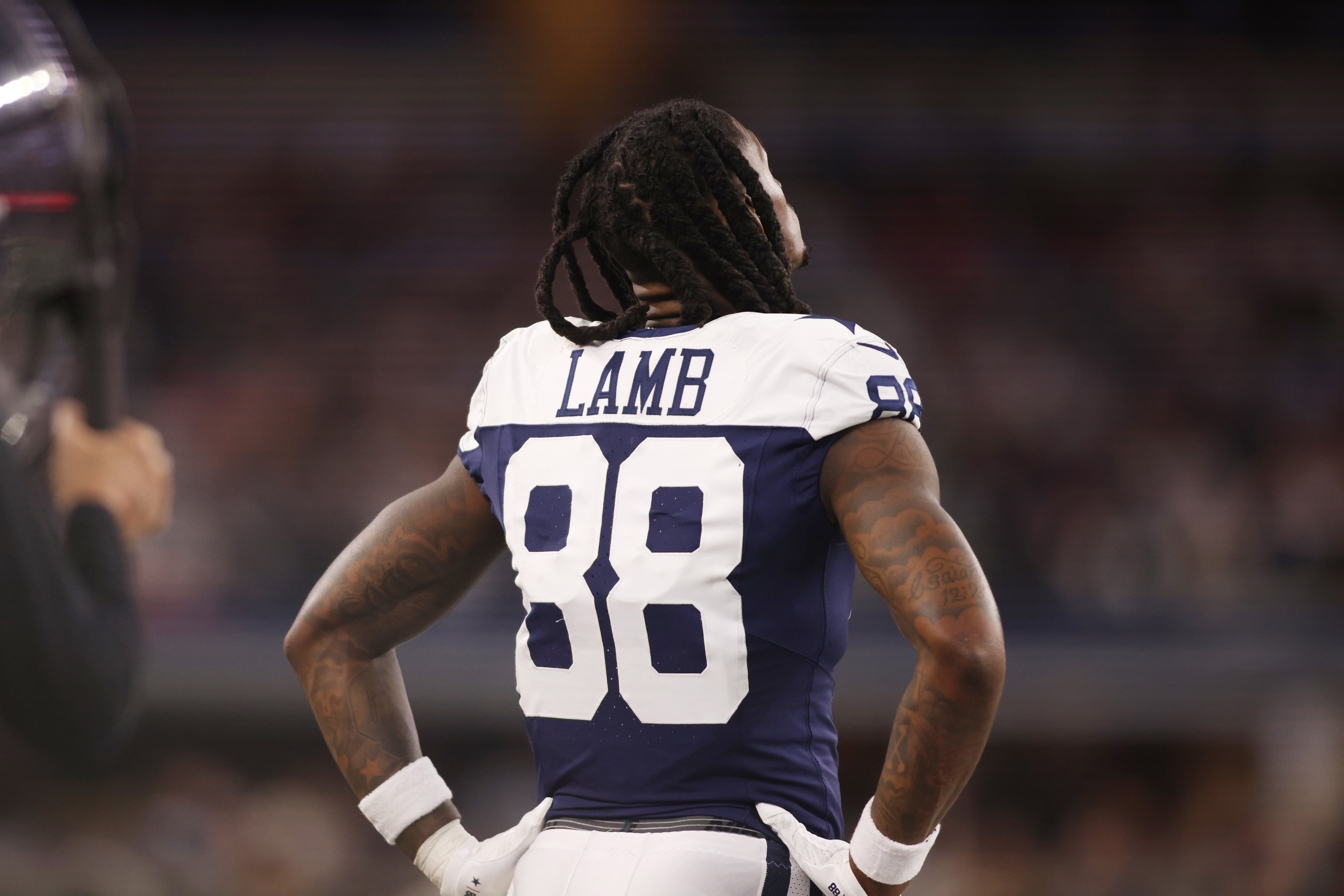 Dallas Cowboys wide receiver CeeDee Lamb (88) watches the game from the sidelines during the game against the Washington Commanders at AT&T Stadium.