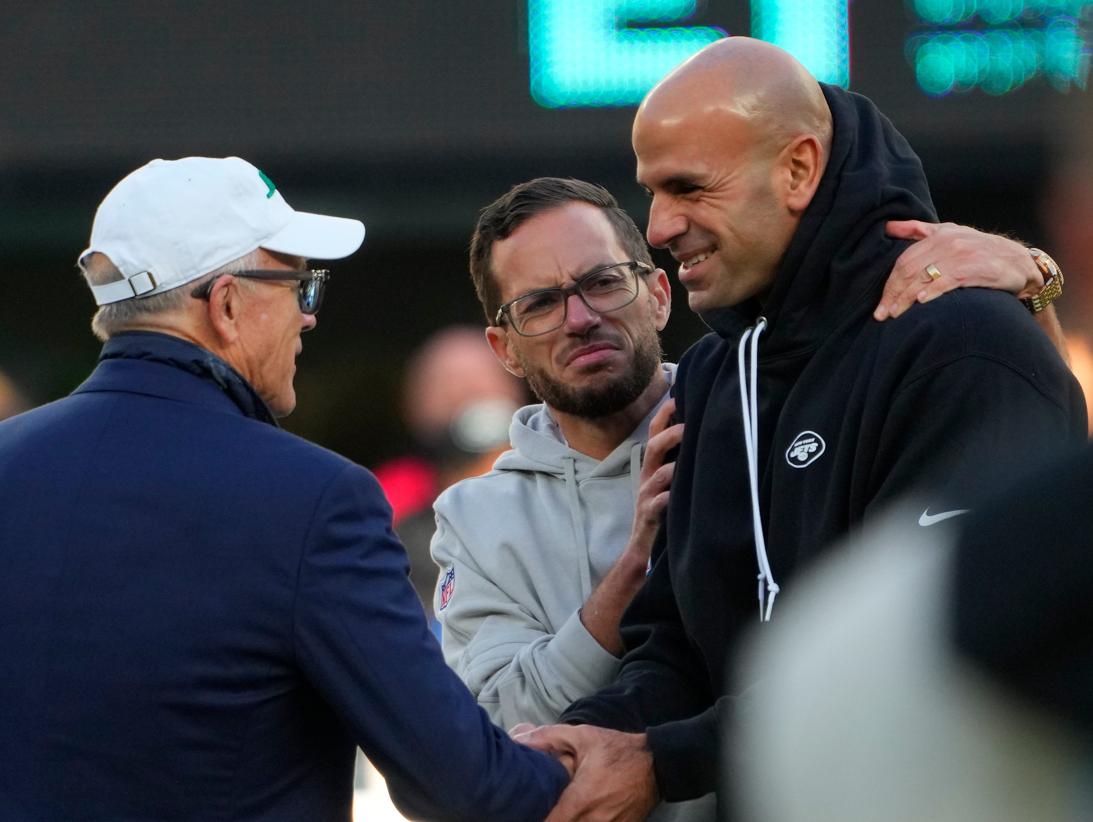 ew York Jets owner Woodie Johnson, left, talks with Miami Dolphins head coach Mike McDaniel, center, and New York Jets head coach Robert Saleh, right, prior to the game at MetLife Stadium.
