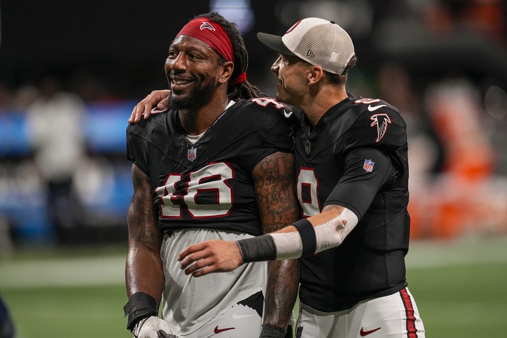 Atlanta Falcons linebacker Bud Dupree and quarterback Desmond Ridder react after defeating the New Orleans Saints at Mercedes-Benz Stadium.