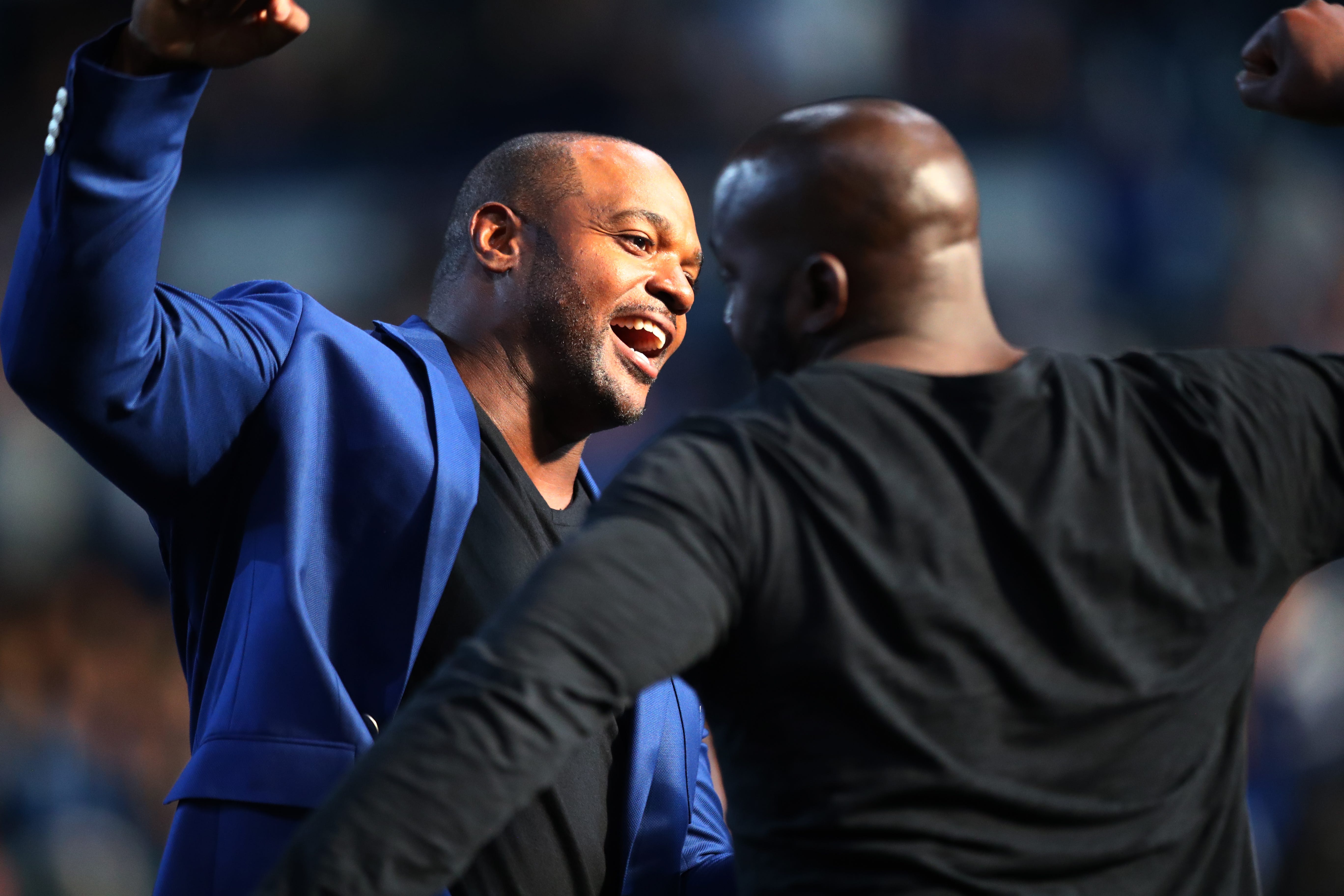 Robert Mathis (right) is greeted by fellow Colts great Dwight Freeney during Mathis Colts Ring of Honor ceremony Sunday, Nov. 28, 2021, during a game against the Tampa Bay Buccaneers at Lucas Oil Stadium in Indianapolis. The combination defensive lineman and linebacker was a key part of the defense that won the 2007 Super Bowl.